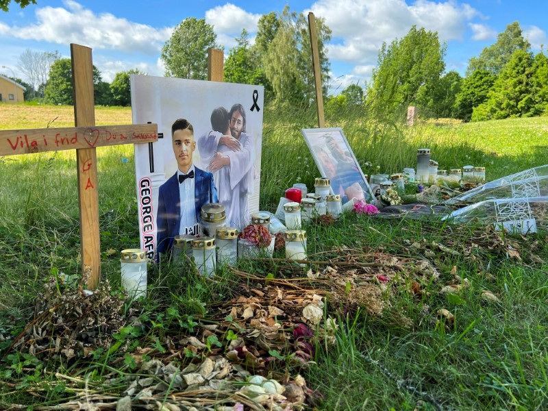 Flowers and other objects are placed at a memorial site for young men shot dead in the suburb of Varberga in May