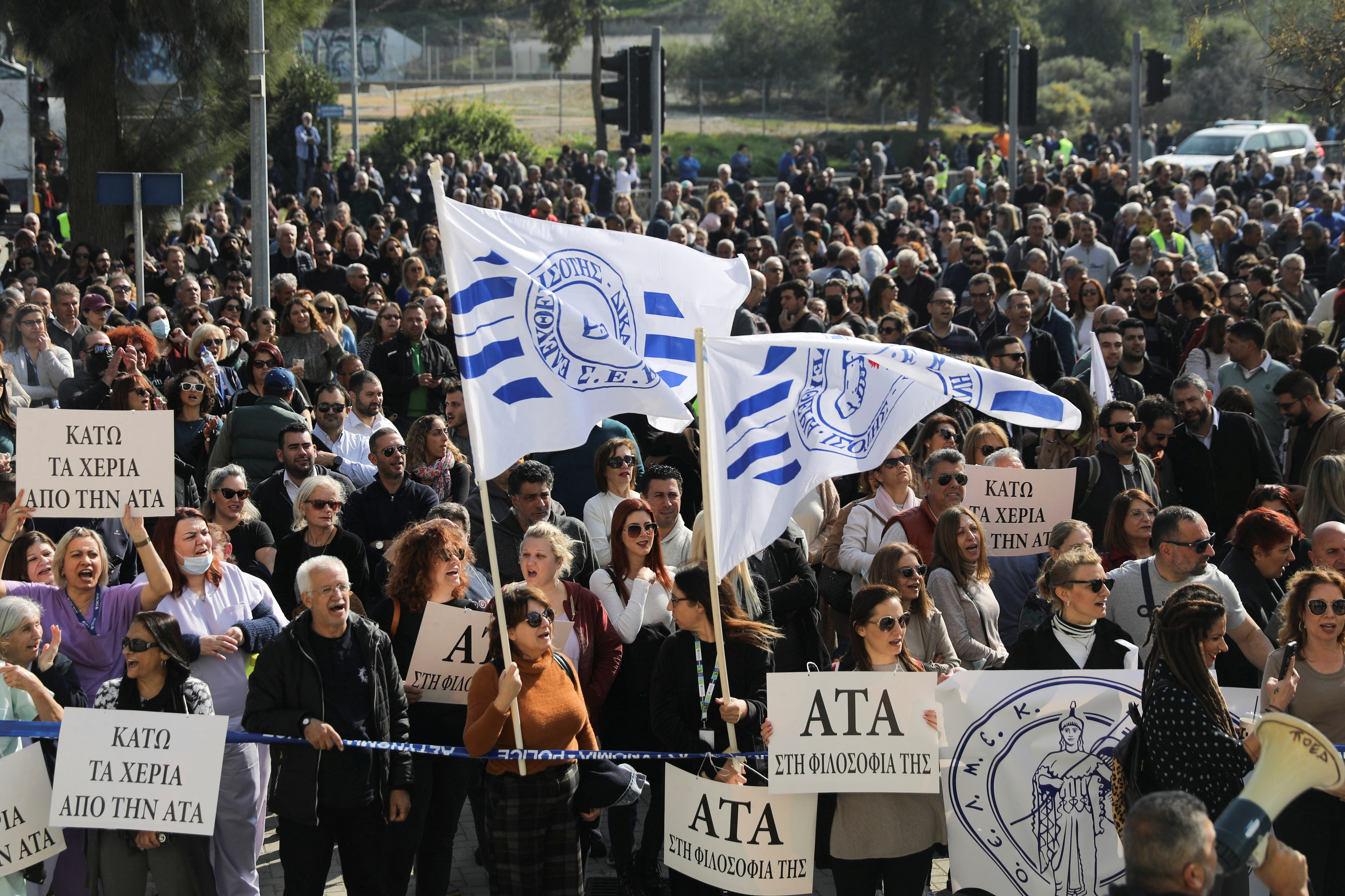 Workers take part in a protest demanding for inflation-linked salary increases outside the Ministry of Finance in Nicosia