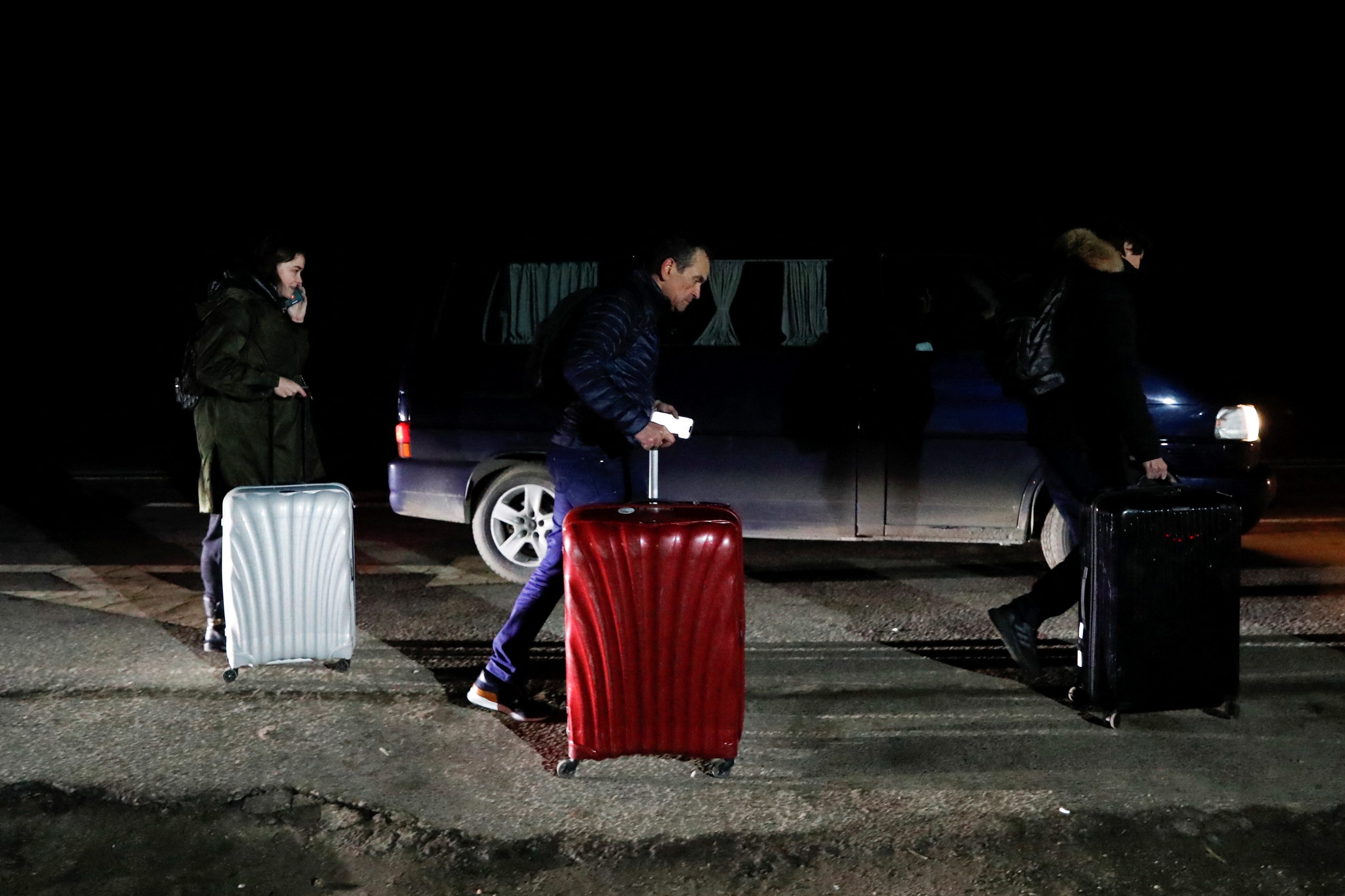 People flee from Ukraine at the Hungarian-Ukrainian border, in Beregsurany
