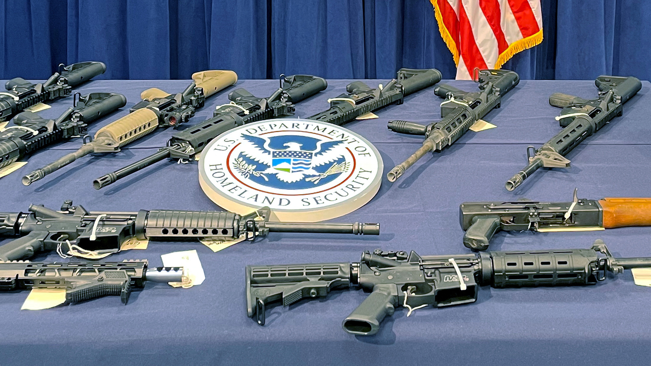 Seized weapons are displayed during a news conference in Miami