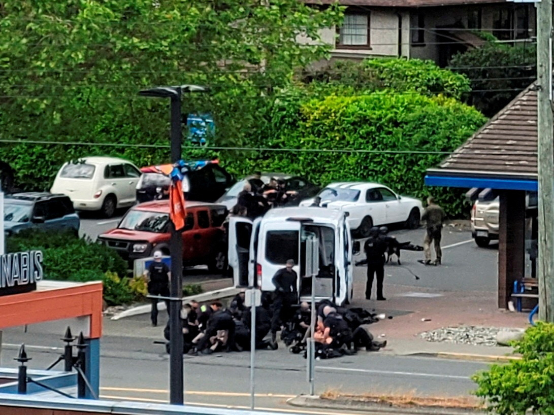 General view of the site where two armed suspects died and six police officers were shot, during an incident at a bank in Saanich, British Columbia