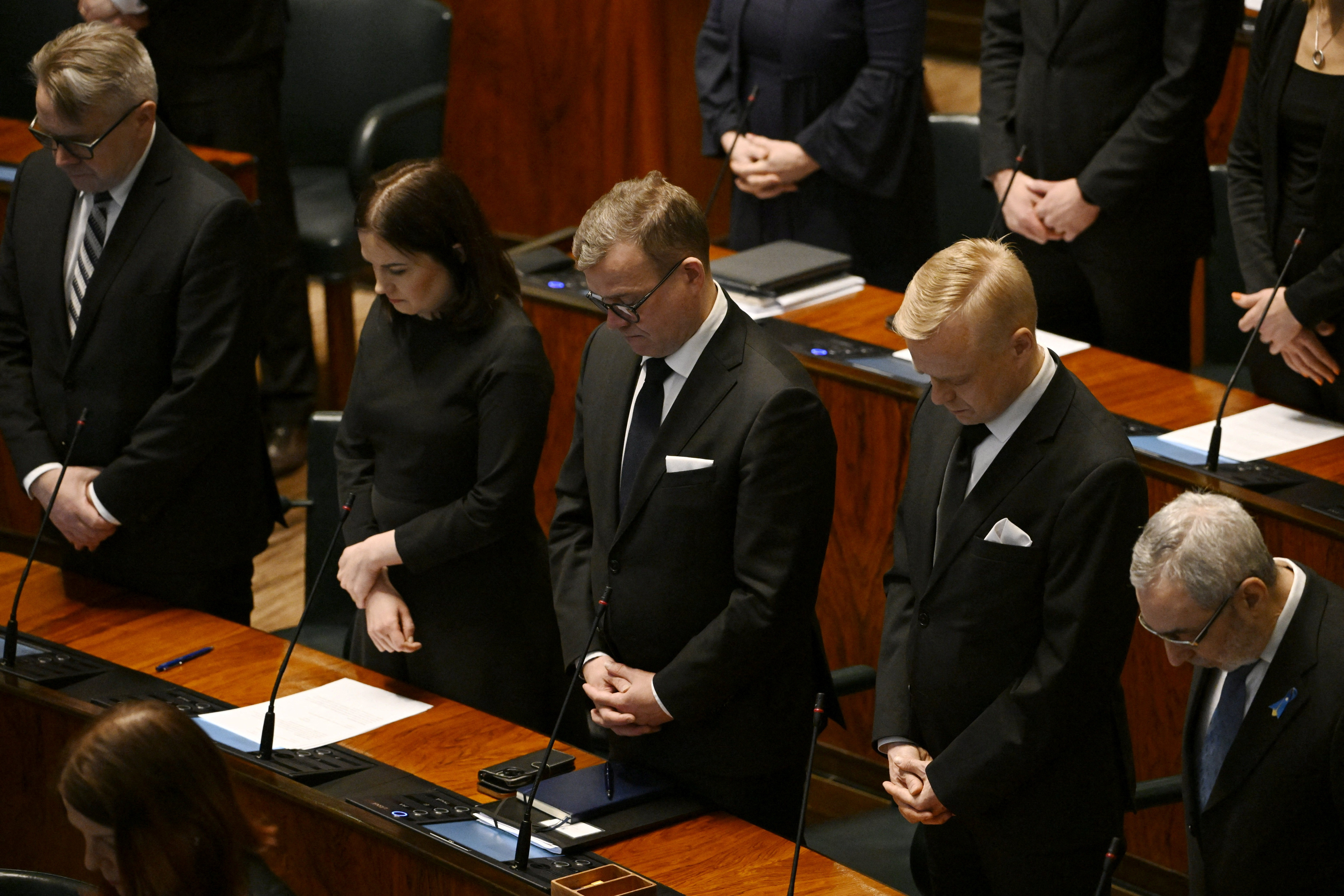 Members of the Finnish parliament pay their respect to the victims of the school shooting ahead of the parliament session, in Helsinki