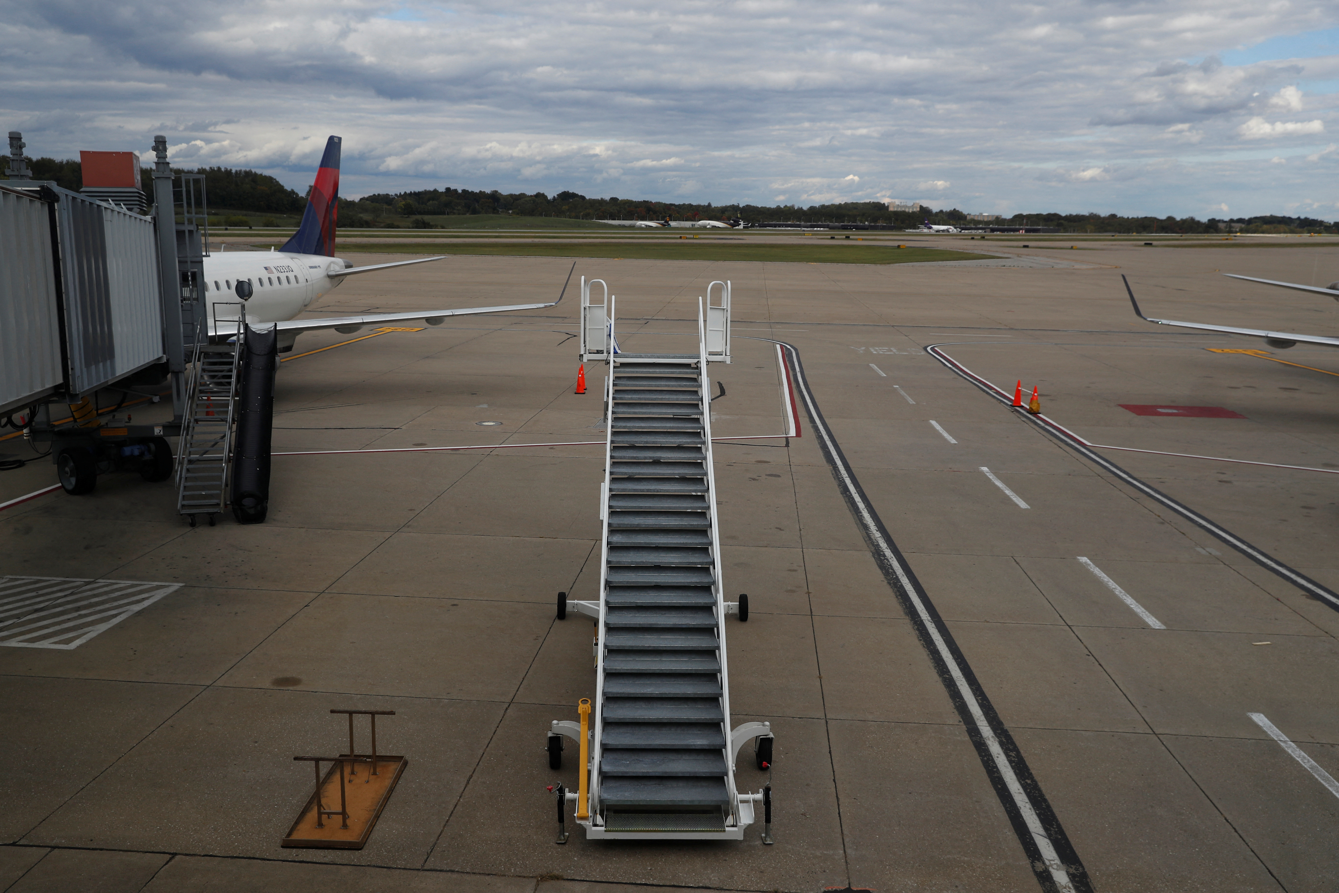 Stairs stand on a tarmac next to a Delta Air Lines plane at Pittsburgh International Airport in Pittsburgh, Pennsylvania