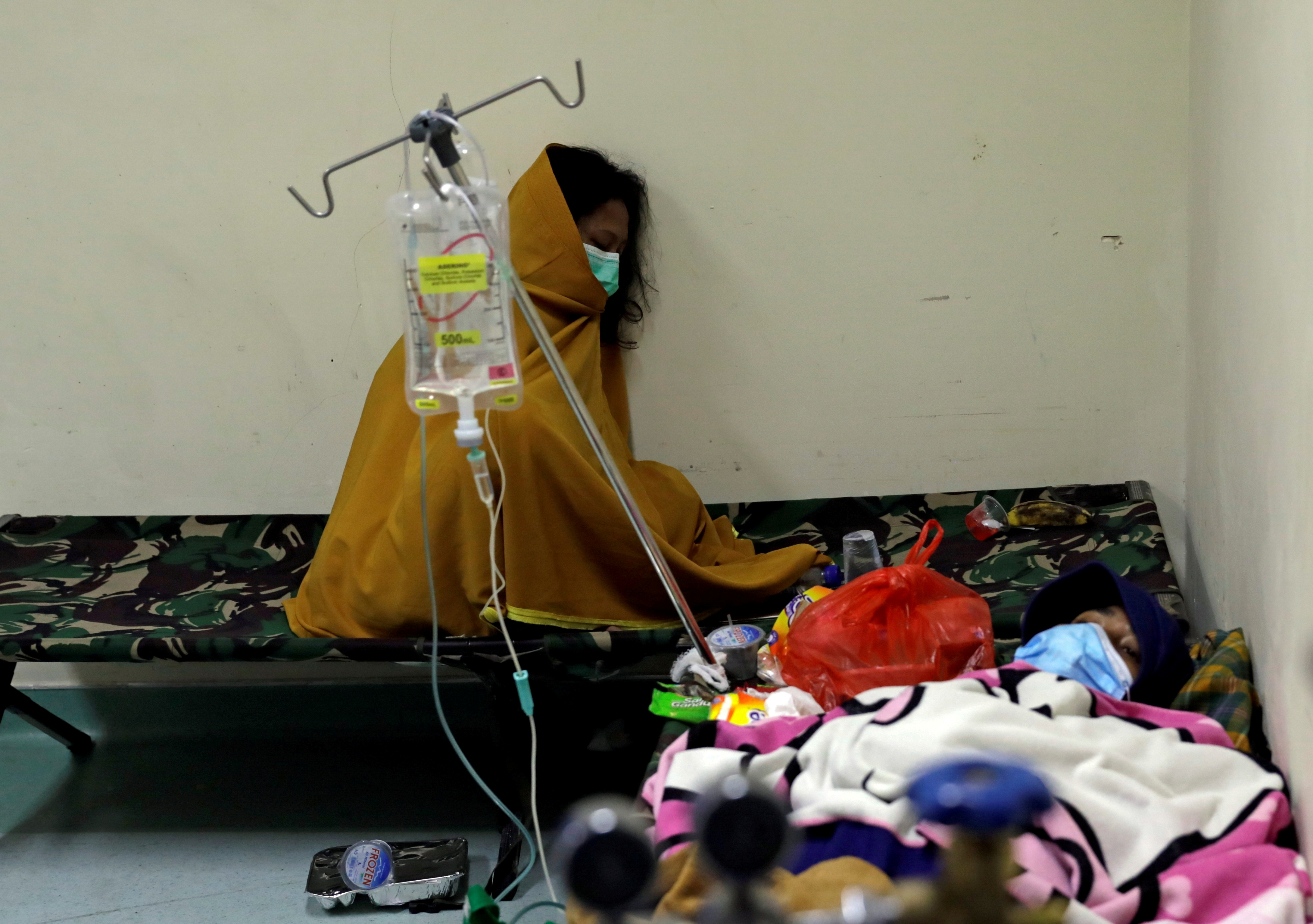 People rest on camp beds inside the emergency ward for coronavirus disease (COVID-19) patients at a government-run hospital in Jakarta, Indonesia, June 29, 2021. REUTERS/Willy Kurniawan