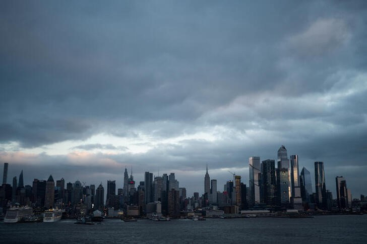 Storm clouds pass by the Empire State Building and middle Manhattan in New York City as seen from Weehawken
