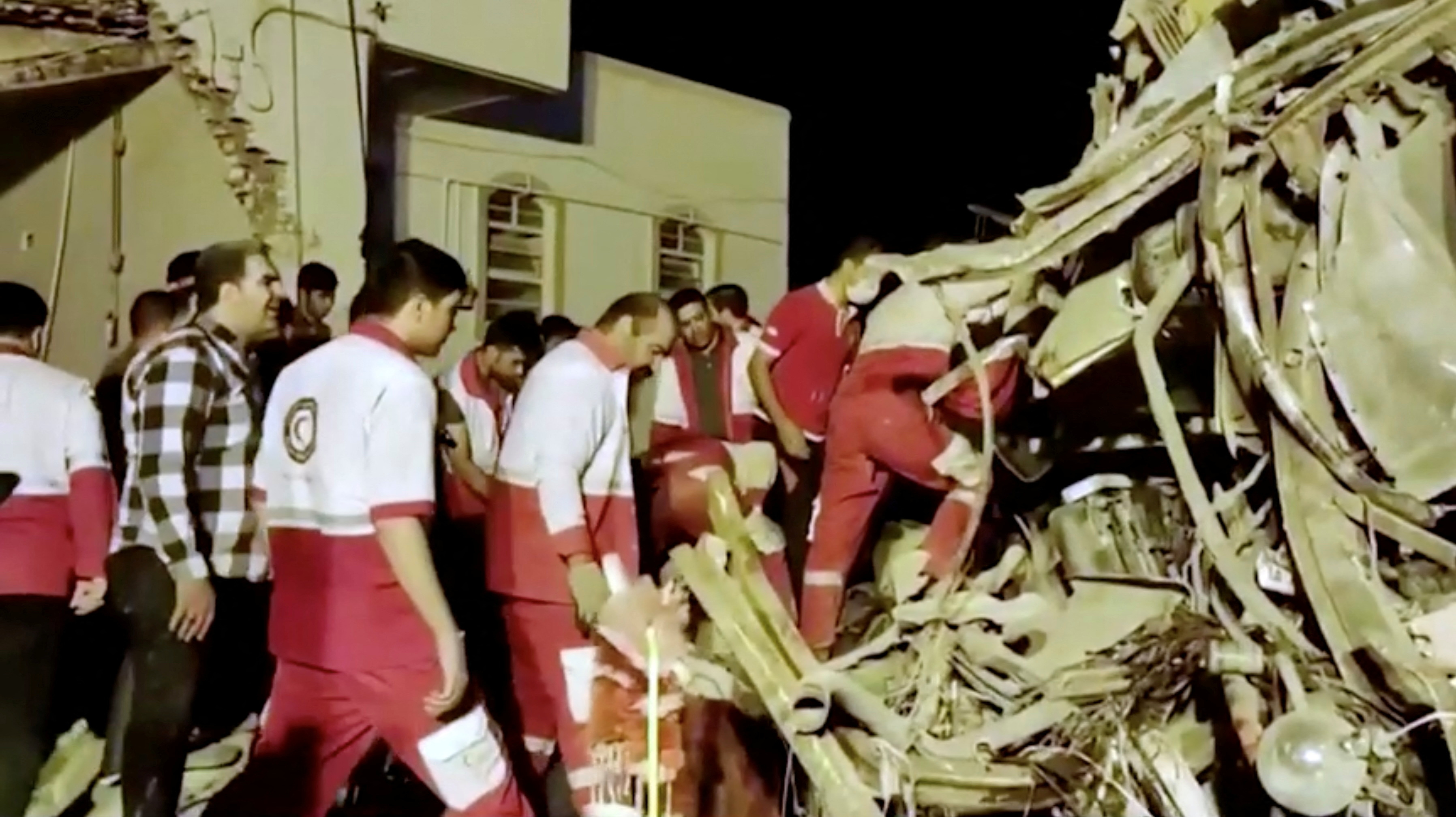 Rescuers work at the scene of bus accident at Yazd province