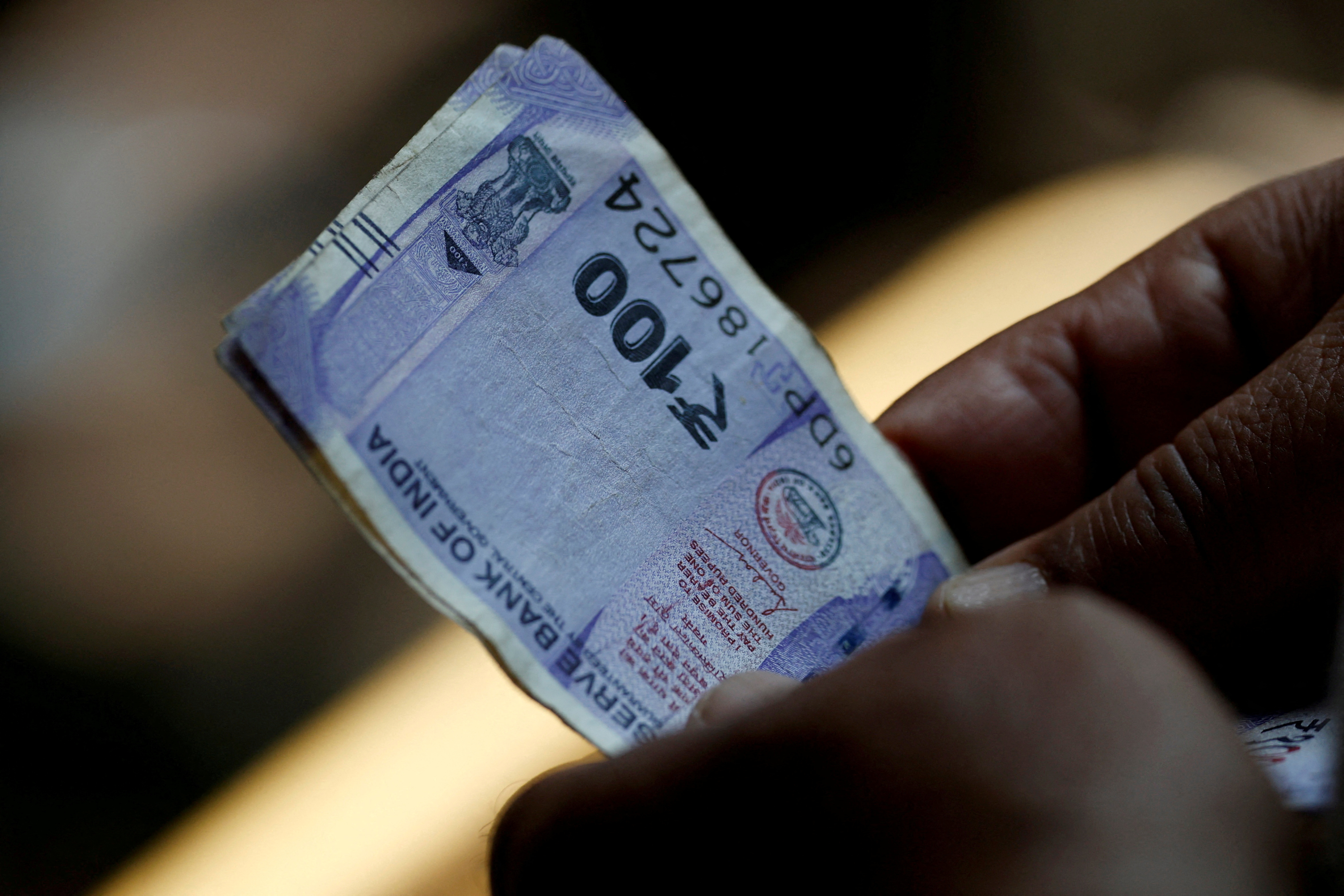 India rupee hits record low, bond yields dip as change of guard at RBI  spurs rate cut bets | Reuters