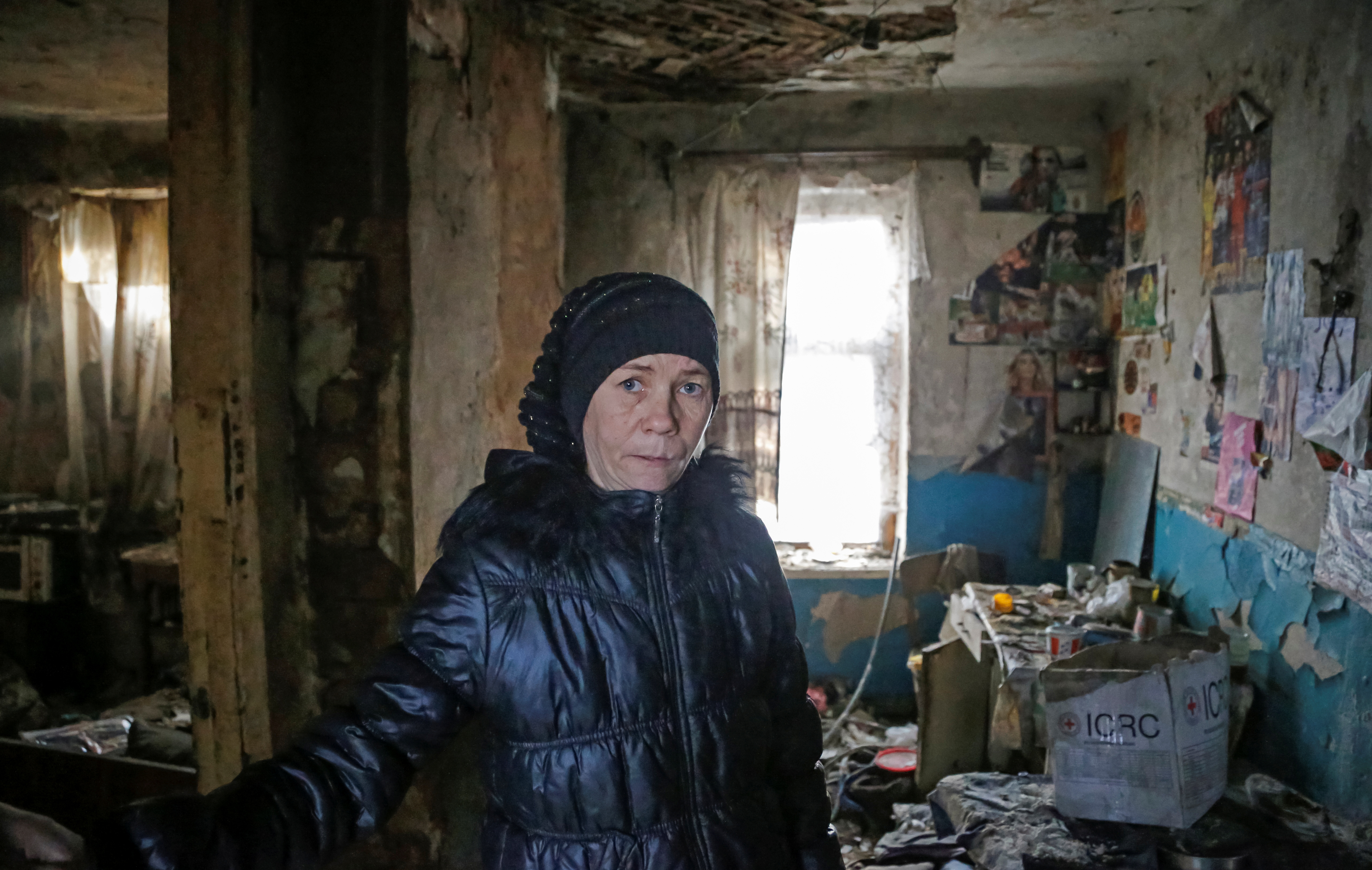 Local resident Irina Studenikina poses inside her house, which was damaged by shelling, in Horlivka