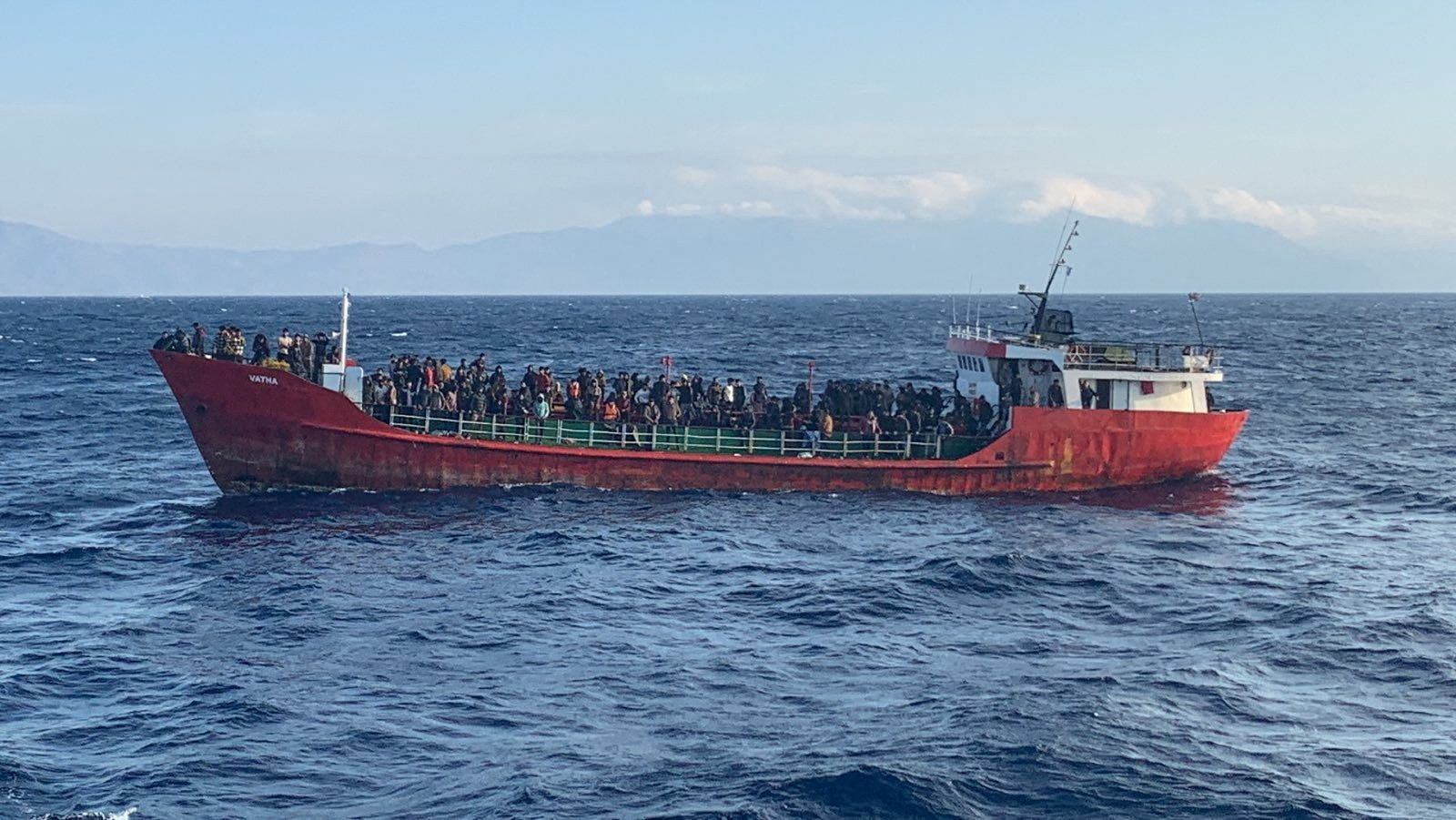 Cargo ship carries migrants during a rescue operation, as it sails off the island of Crete