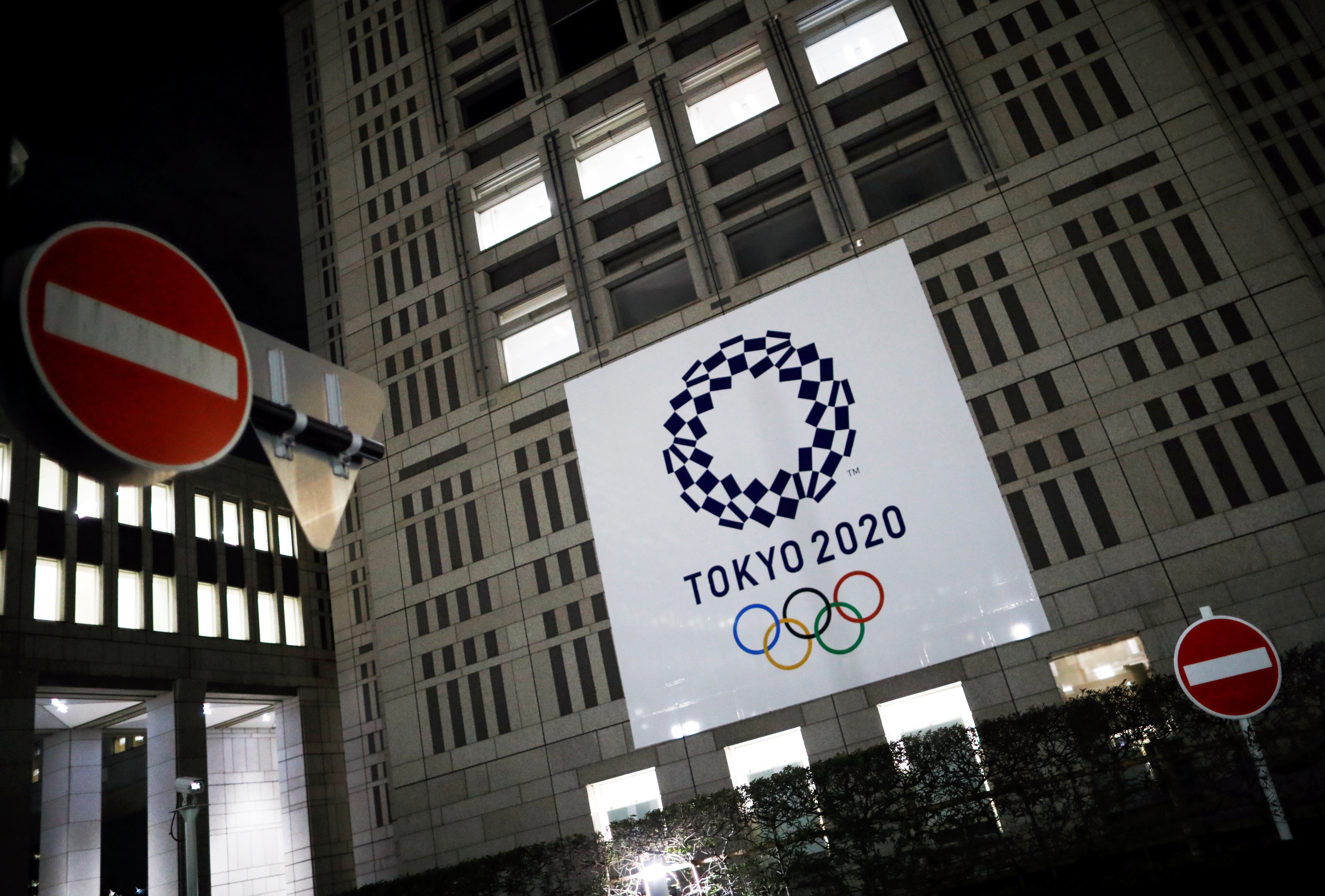 The logo of Tokyo 2020 Olympic Games is seen through signboards, in Tokyo