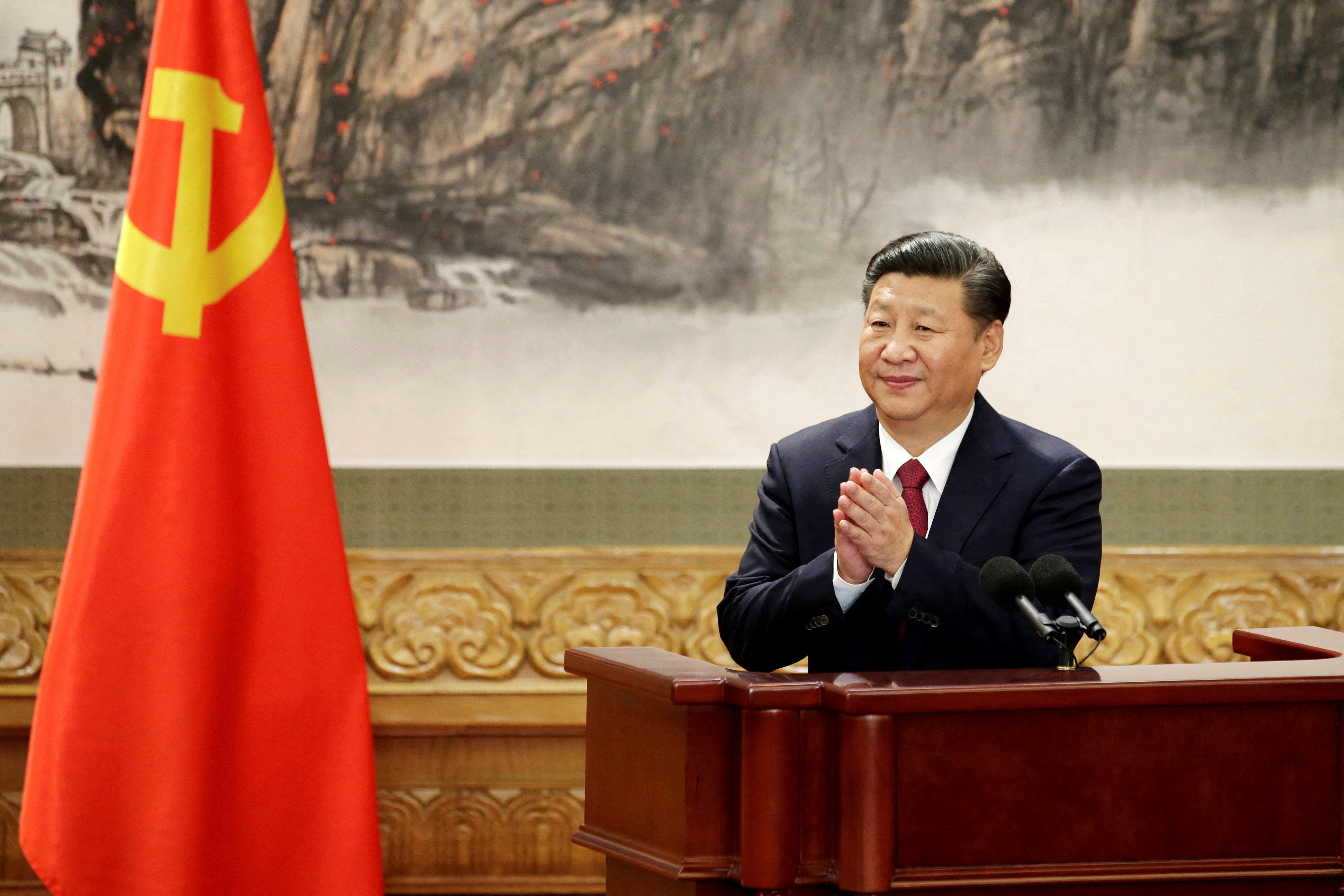 Chinese President Xi Jinping claps after his speech in Beijing