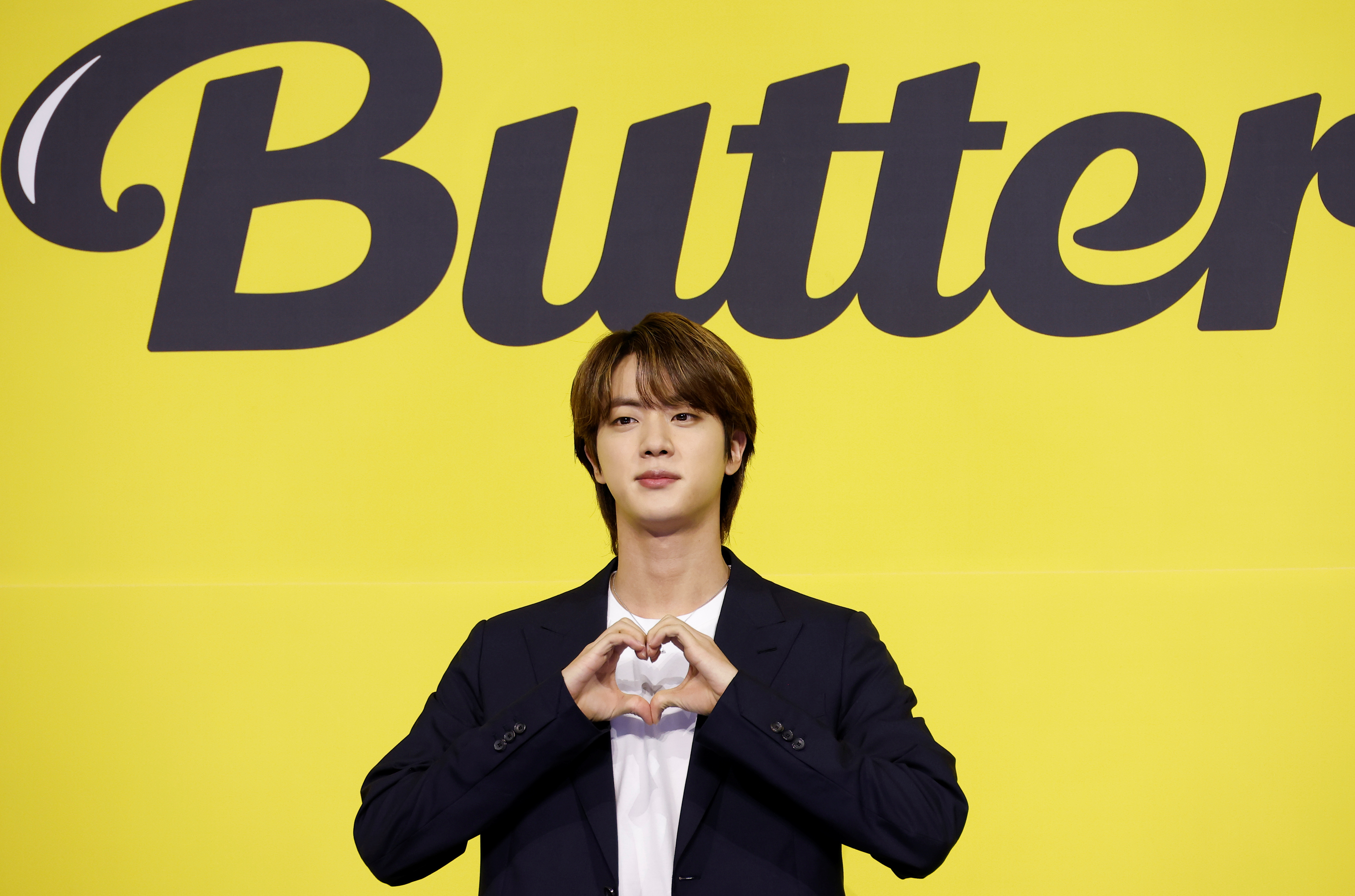 K-pop boy band BTS member Jin poses for photographs during a photo opportunity promoting their new single 'Butter' in Seoul