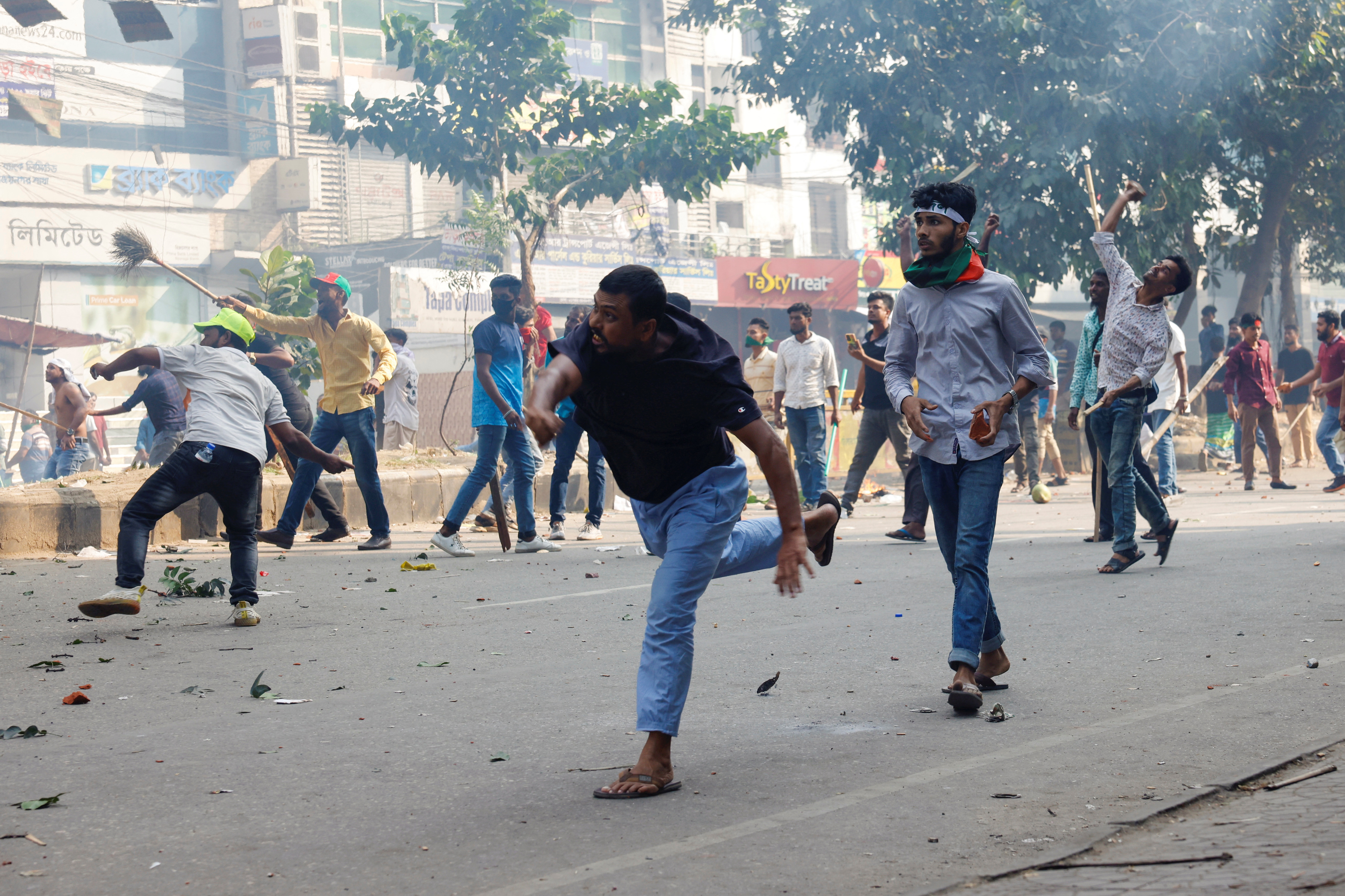 Supporters of Bangladesh Nationalist Party (BNP) throw brickbats towards police during a clash in Dhaka