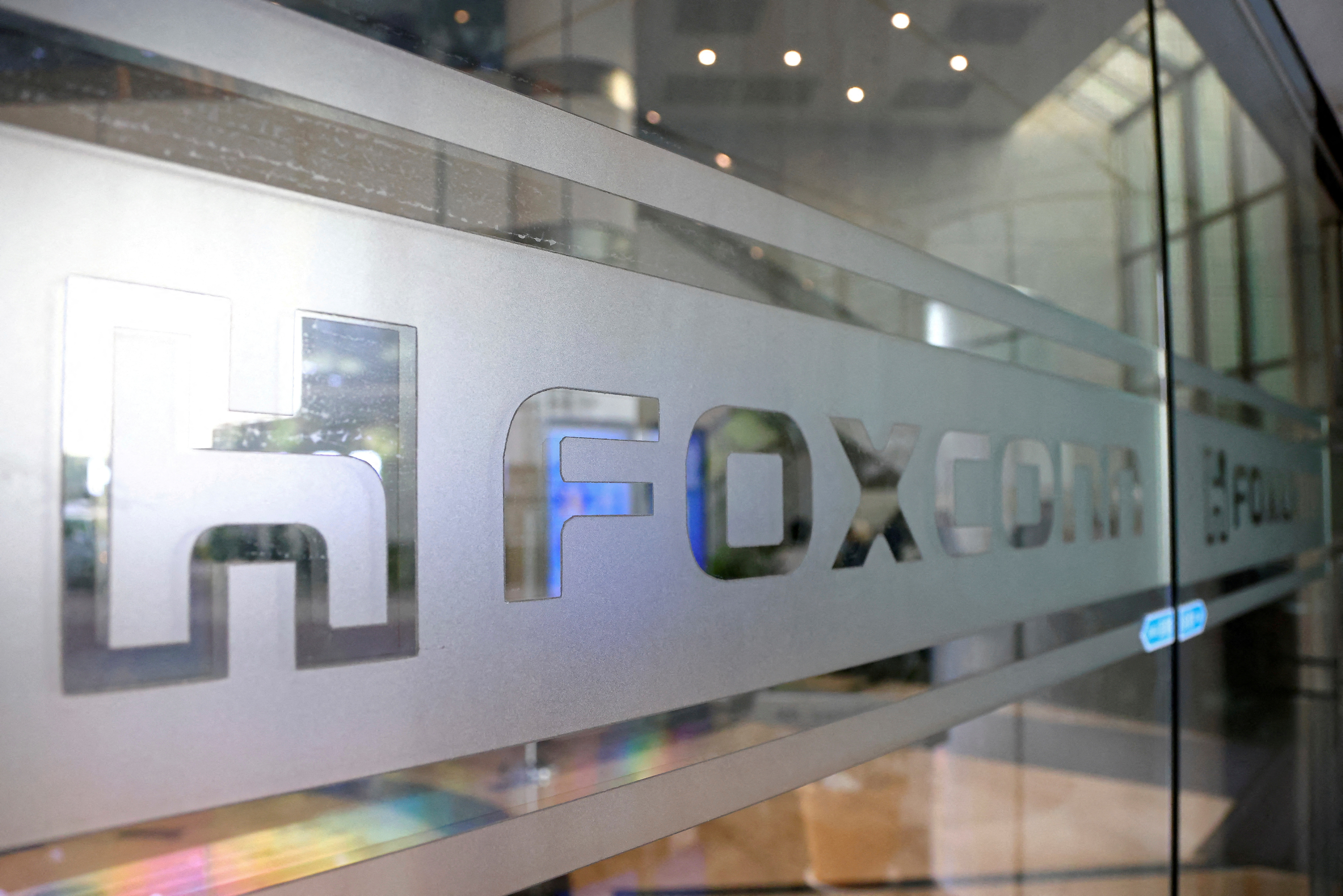 The Foxconn logo is seen on a glass door at its office building in Taipei.
