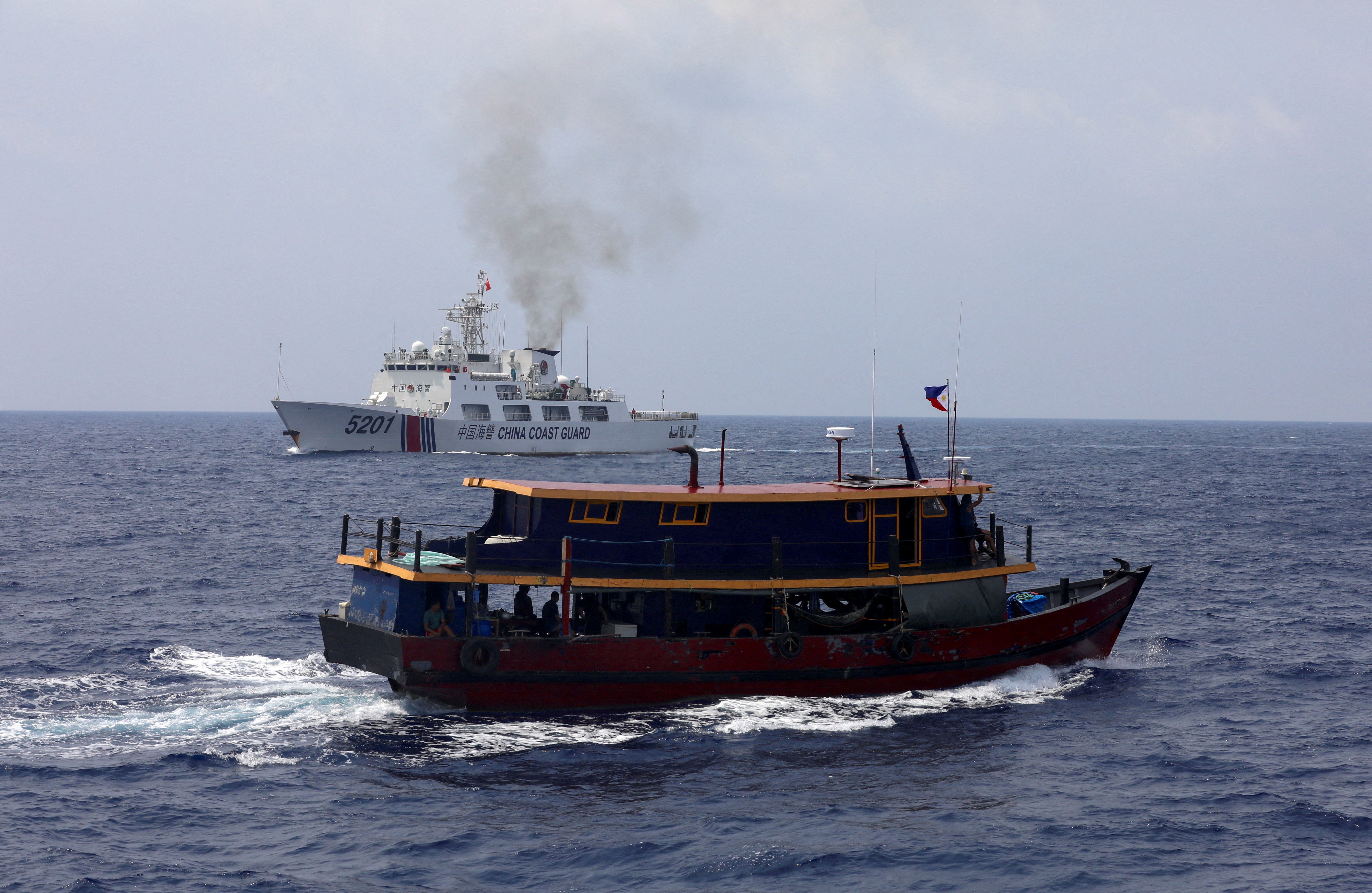 China's coast guard pursue Filipino fisherman in disputed waters
