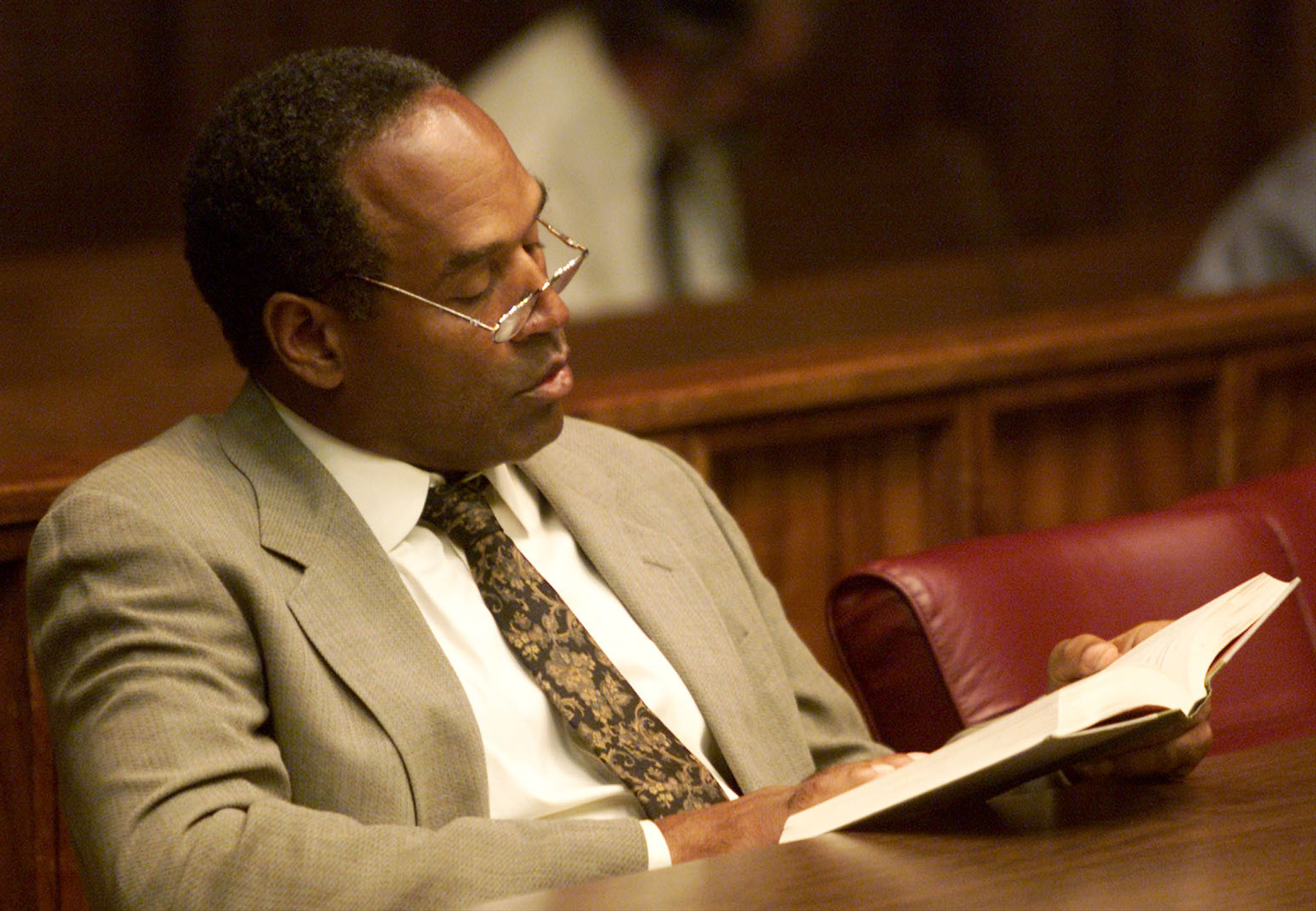 OJ SIMPSON READS A BOOK BEFORE THIRD DAY OF JURY SELECTION.