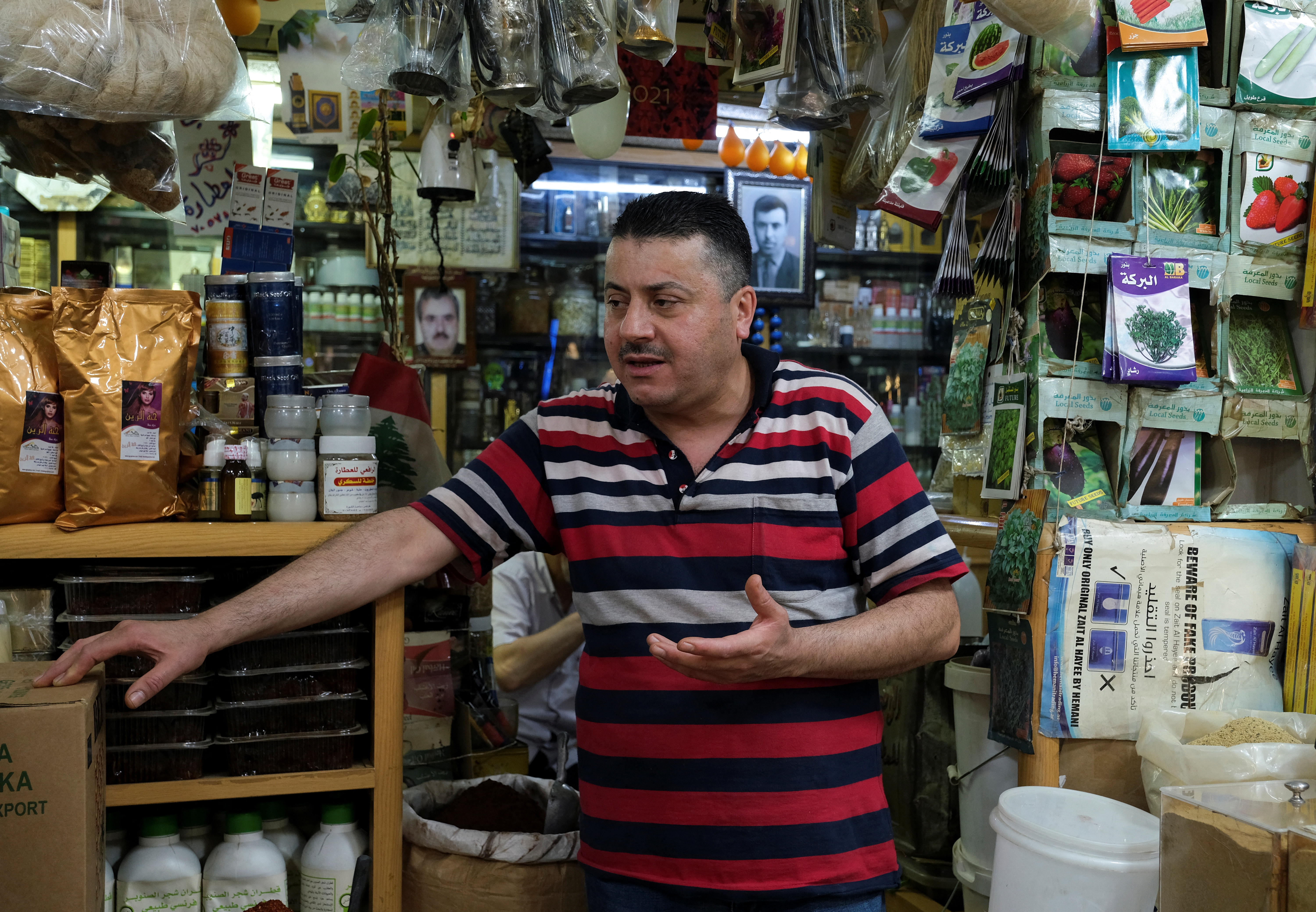 Apothecarist Omar al-Rafie, 48, speaks during an interview with Reuters at his shop in Tripoli