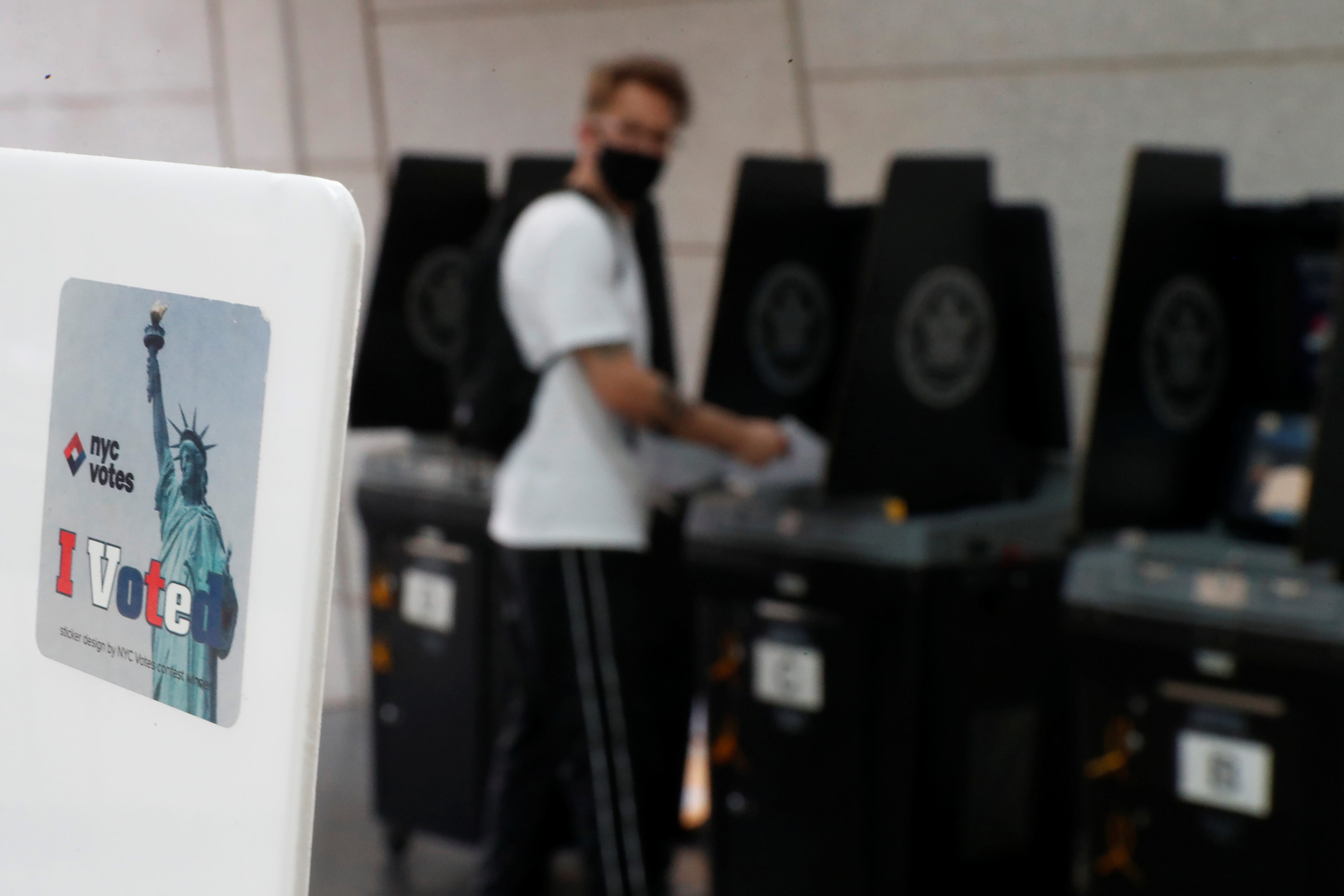 A voting sticker with the Statue of Liberty is seen as a voter casts his ballot in the New York Primary election