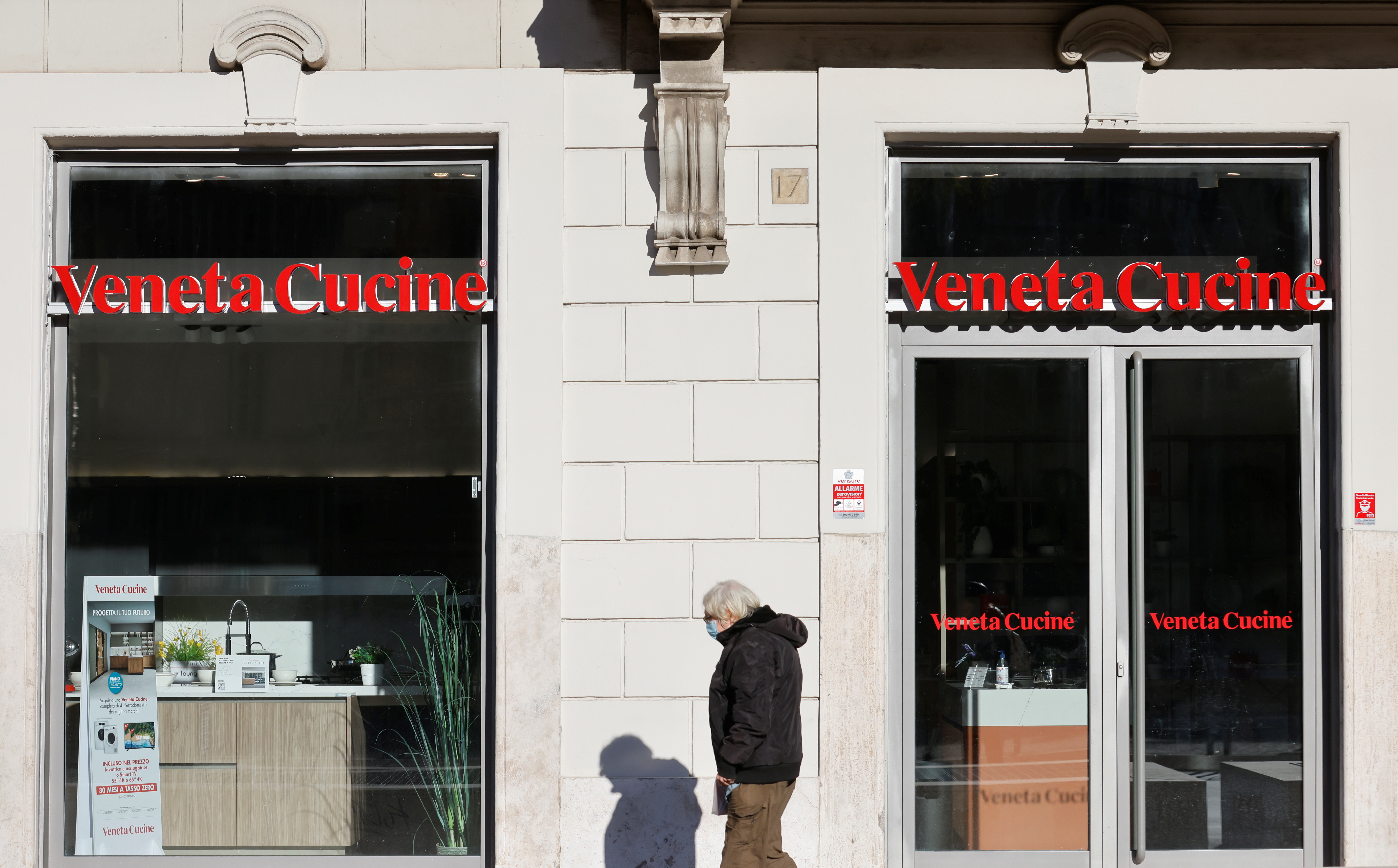 A man walks past Veneta Cucine store amid the COVID-19 pandemic in Rome