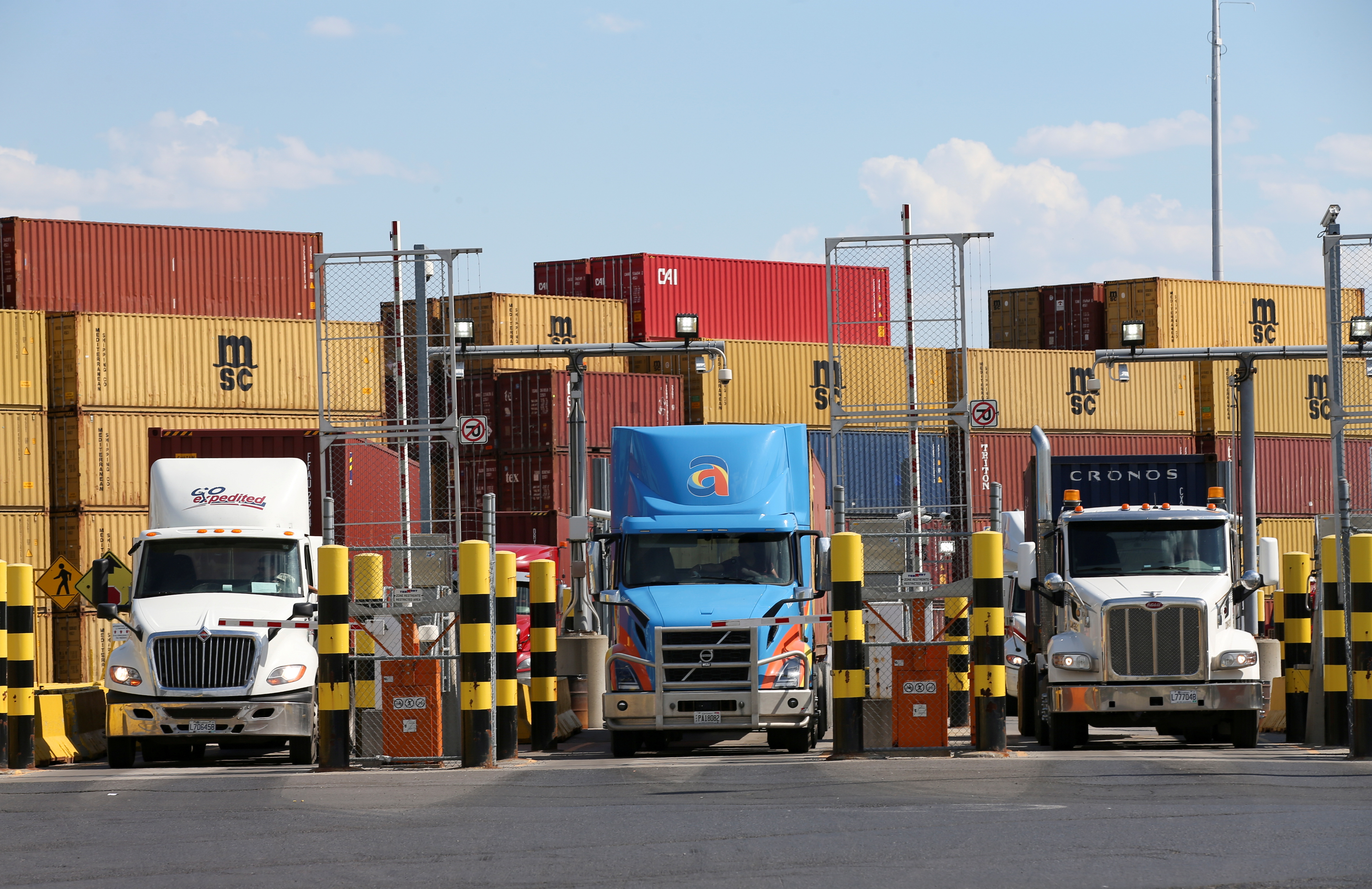 Trucks loaded with shipping containers leave the Port of Montreal in Montreal, Quebec, Canada, May 17, 2021.  REUTERS/Christinne Muschi