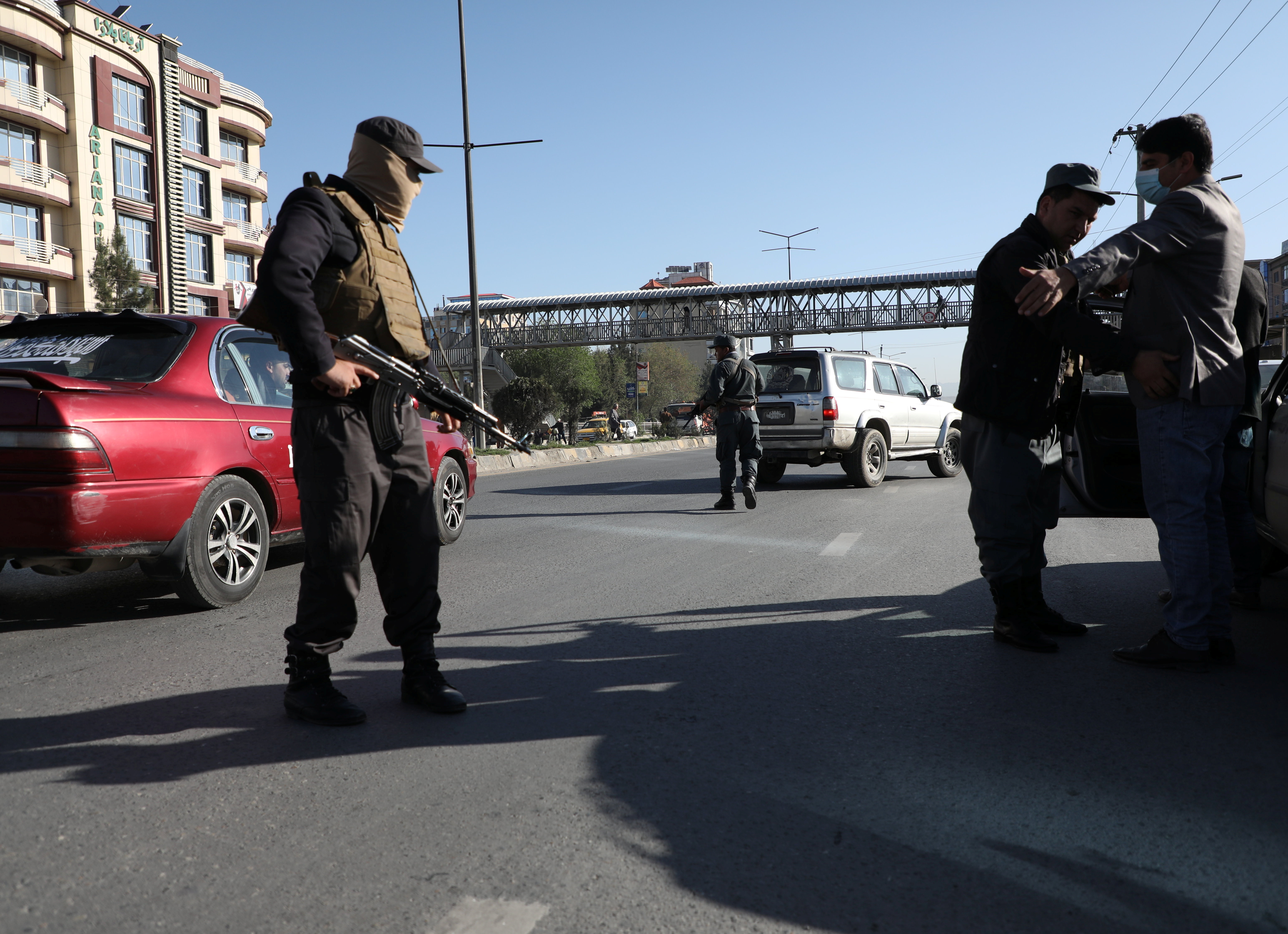 Afghan policemen keep watch at a checkpoint in Kabul, Afghanistan