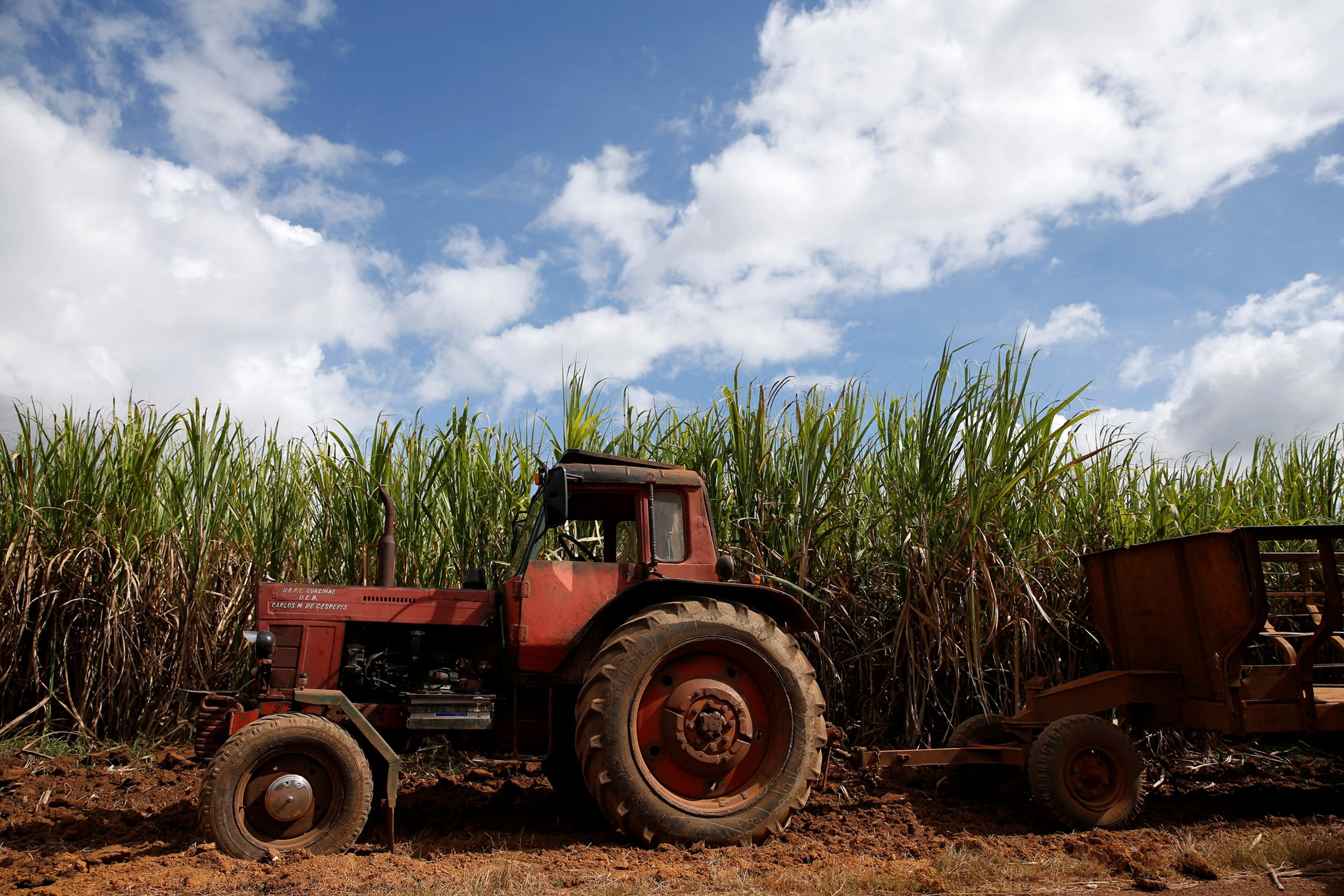 A tractor sits near a sugar cane field in Florida, Cuba
