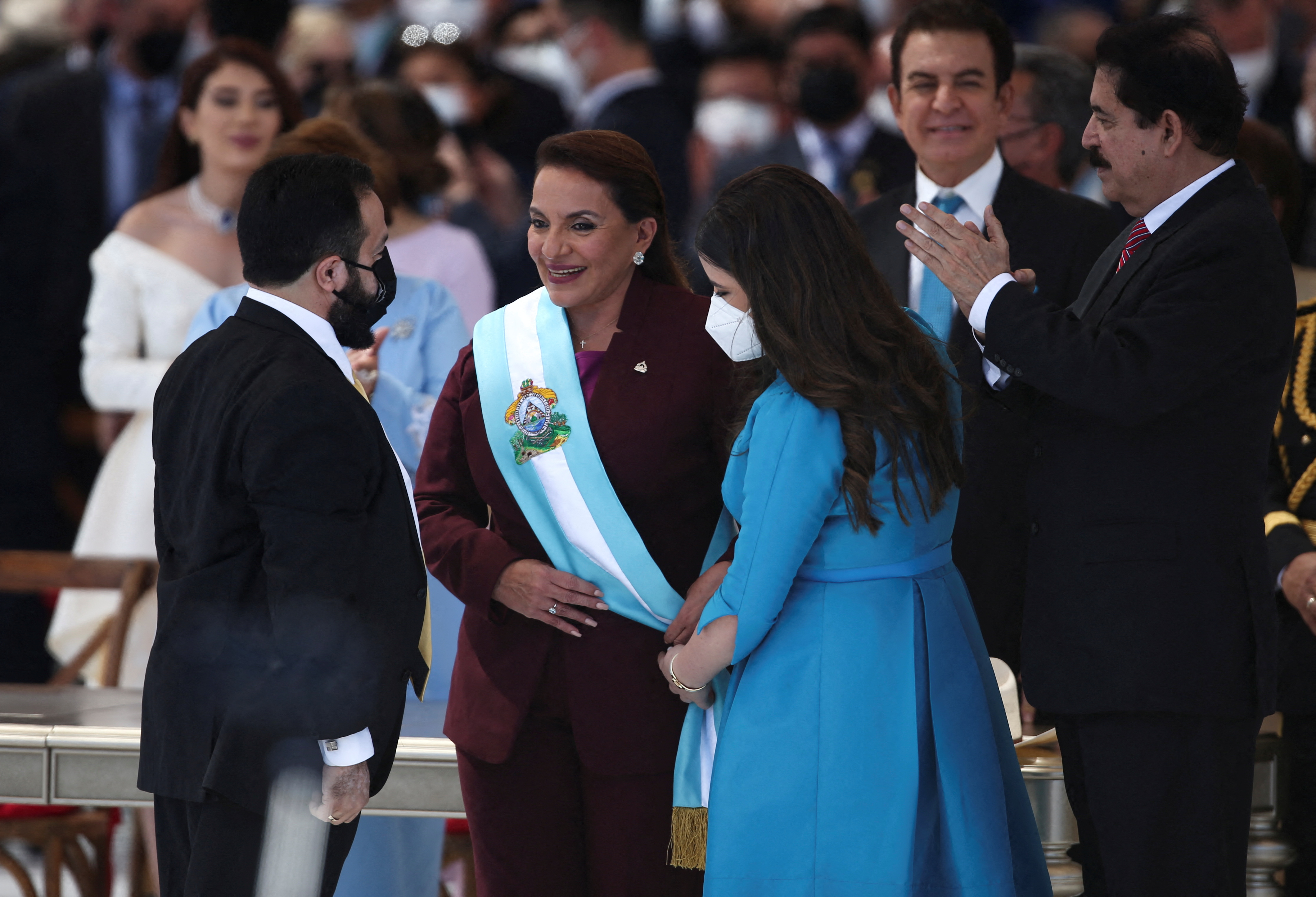 New Honduran President Xiomara Castro receives the presidential sash from her granddaughter, Irene Melara, and the President of the Congress Luis Redondo, during a swearing-in ceremony in Tegucigalpa, Honduras January 27, 2022. REUTERS/Jose Cabezas