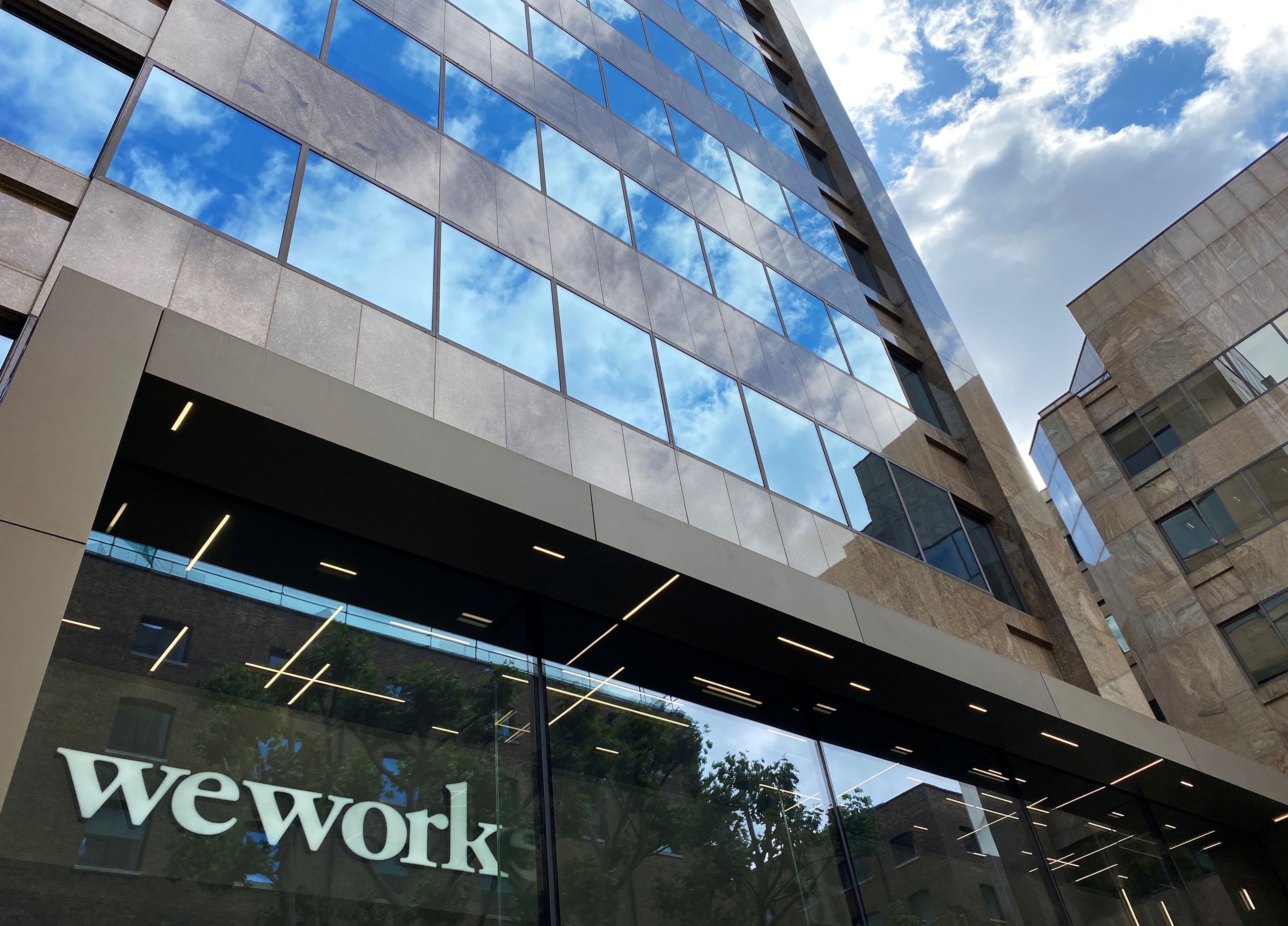 The logo of WeWork is seen in the window of a building in London