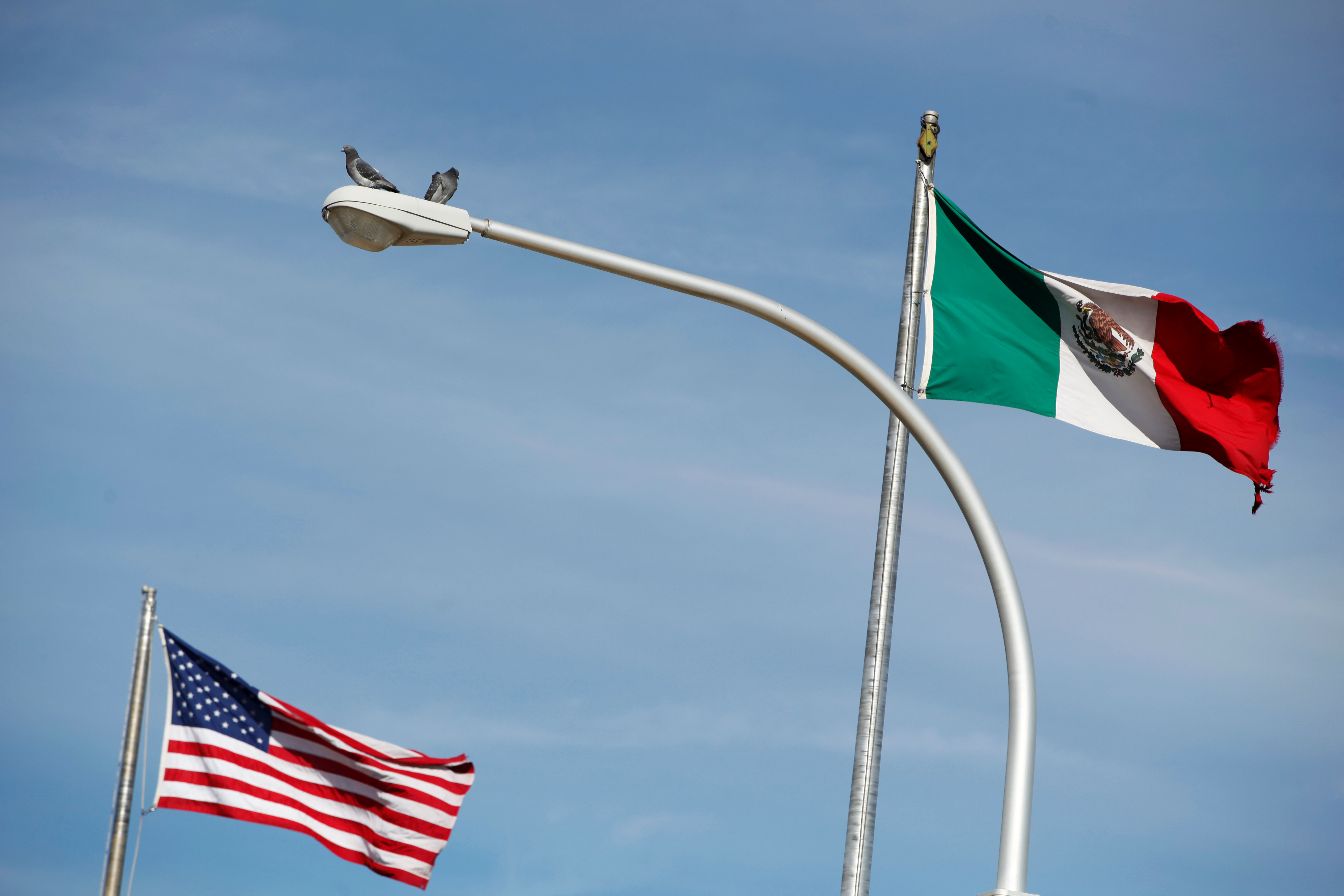 The US flag and the Mexico's flag are pictured on the international border bridge Paso del Norte in between El Paso US and Ciudad Juarez in Ciudad Juarez, Mexico