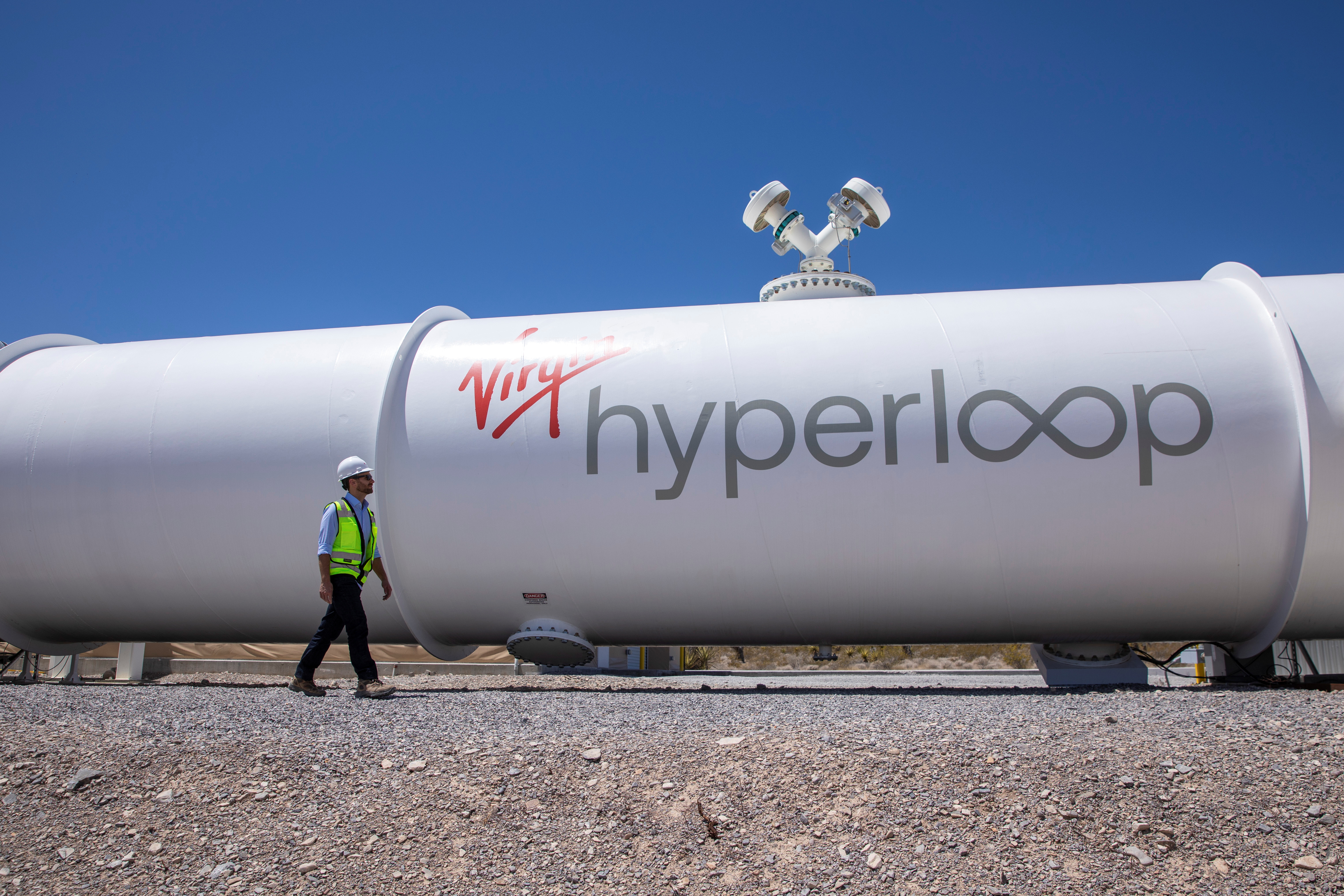 Josh Giegel, co-founder and CEO of Virgin Hyperloop, walks next to a hyperloop tube at the company's hyperloop facility near Las Vegas