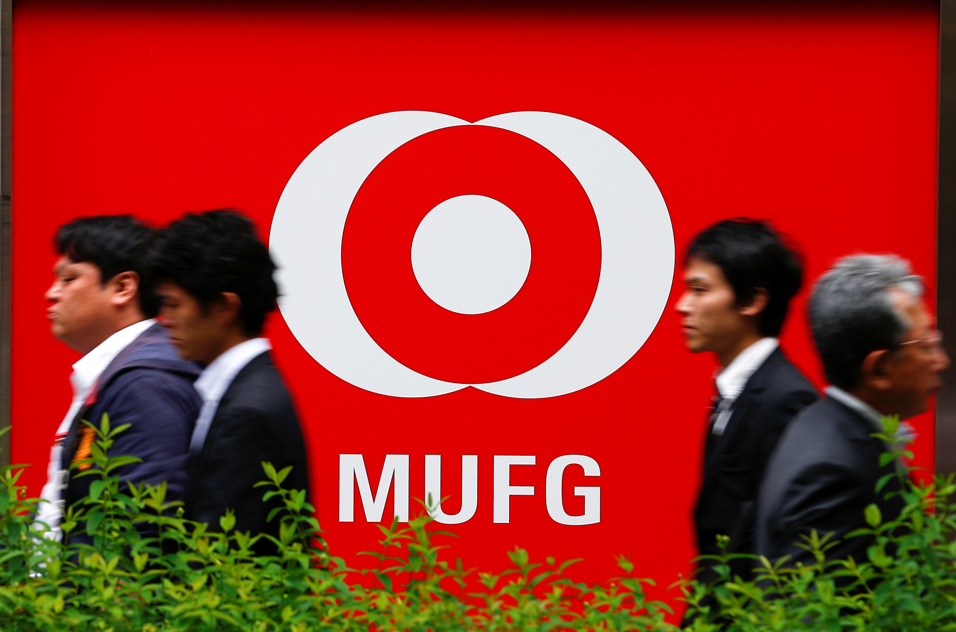 People walk past a branch of Mitsubishi UFJ  Financial Group's bank of Tokyo-Mitsubishi UFJ (MUFG) in Tokyo