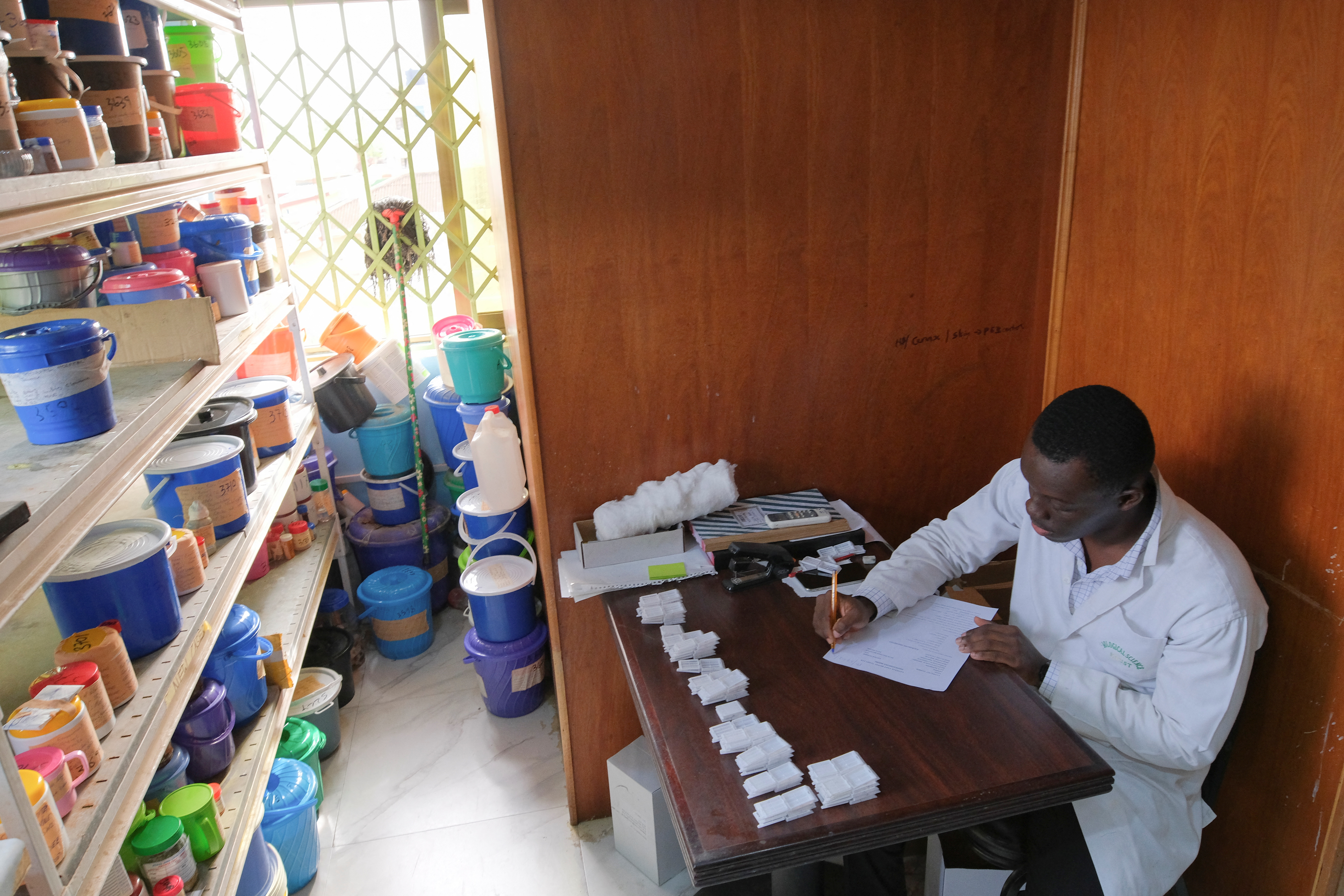 Ron Dickson, 25, a technician, records specimens received at the Pathologists Without Borders laboratory in Accra