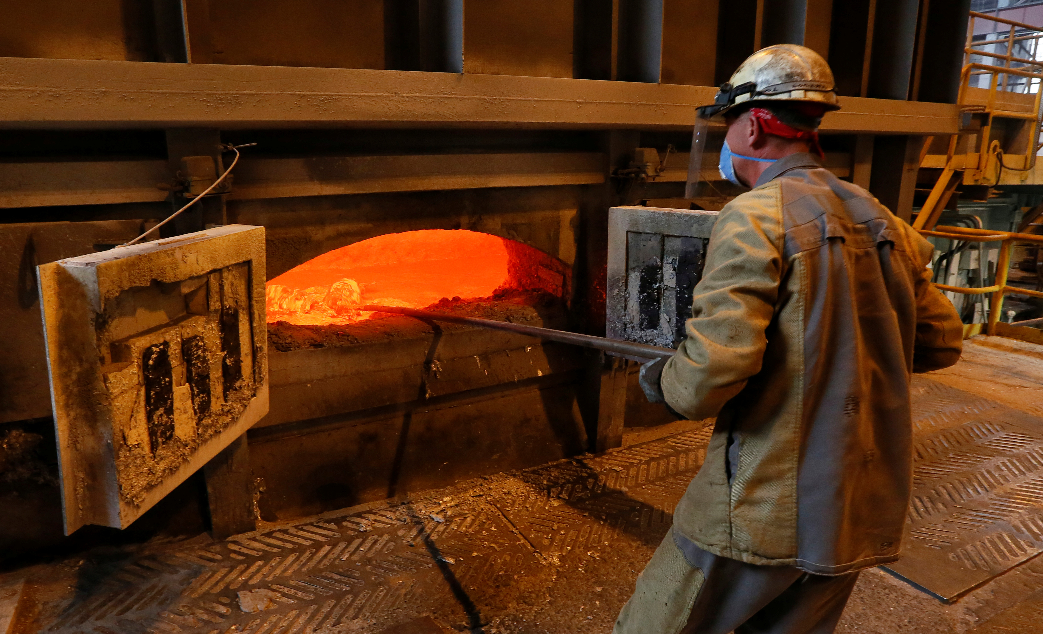 Employee works near mixer of fused aluminium at foundry shop of Rusal Krasnoyarsk aluminium smelter in Krasnoyarsk
