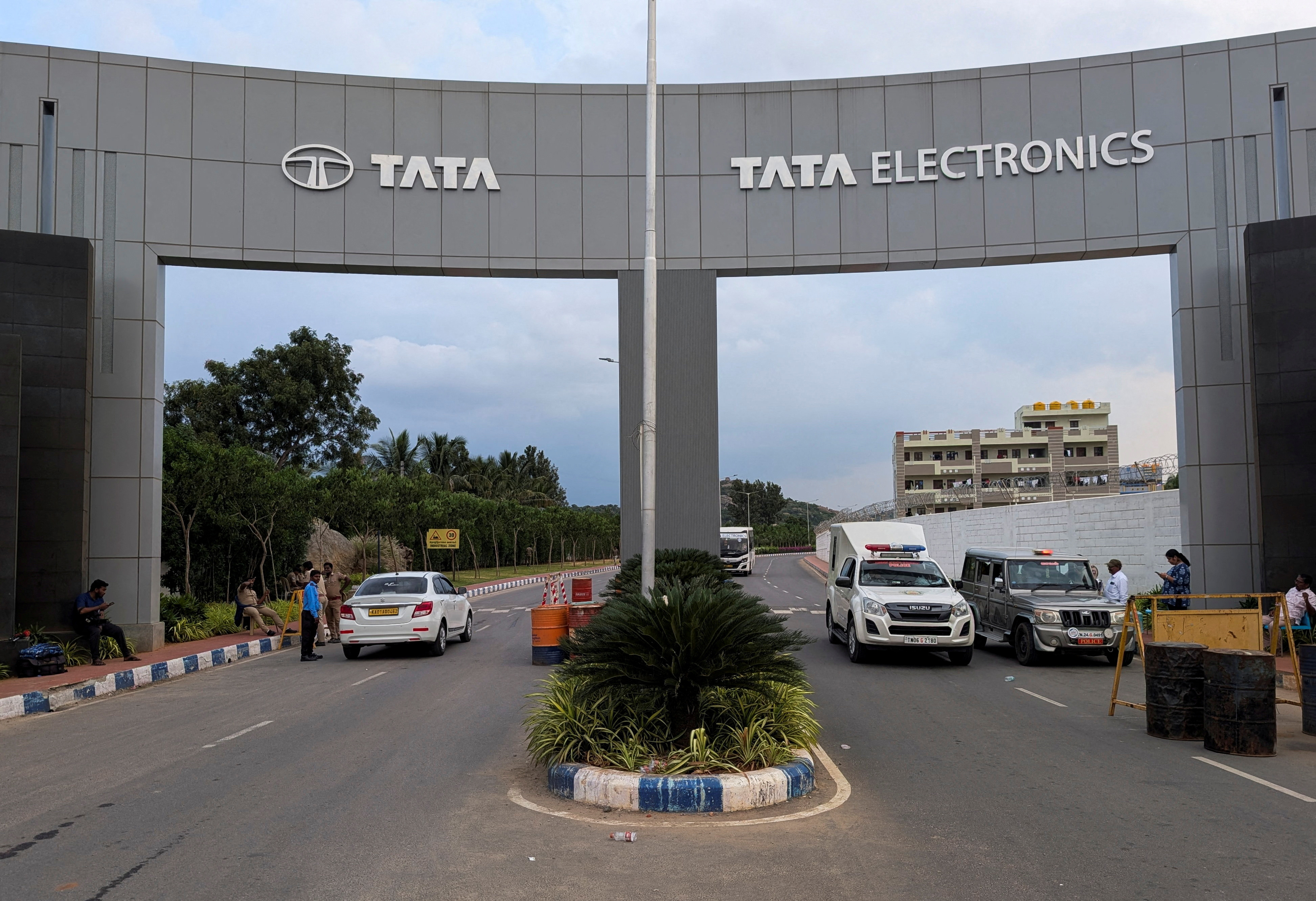 Vehicles pass through the entrance of a Tata Electronics plant which makes Apple iPhone components in India