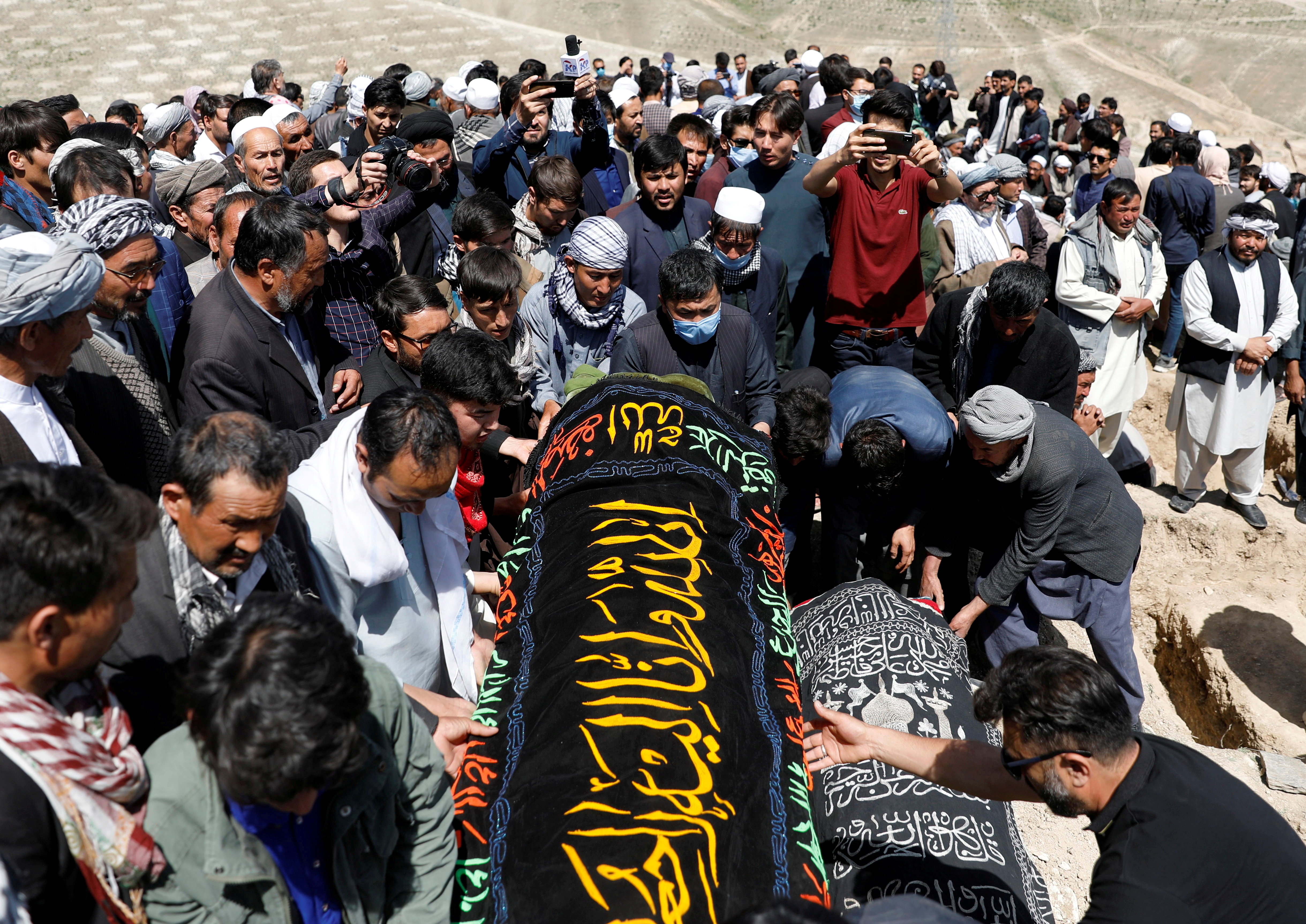 Afghan men prepare victims' coffins for mass funeral ceremony in Kabul