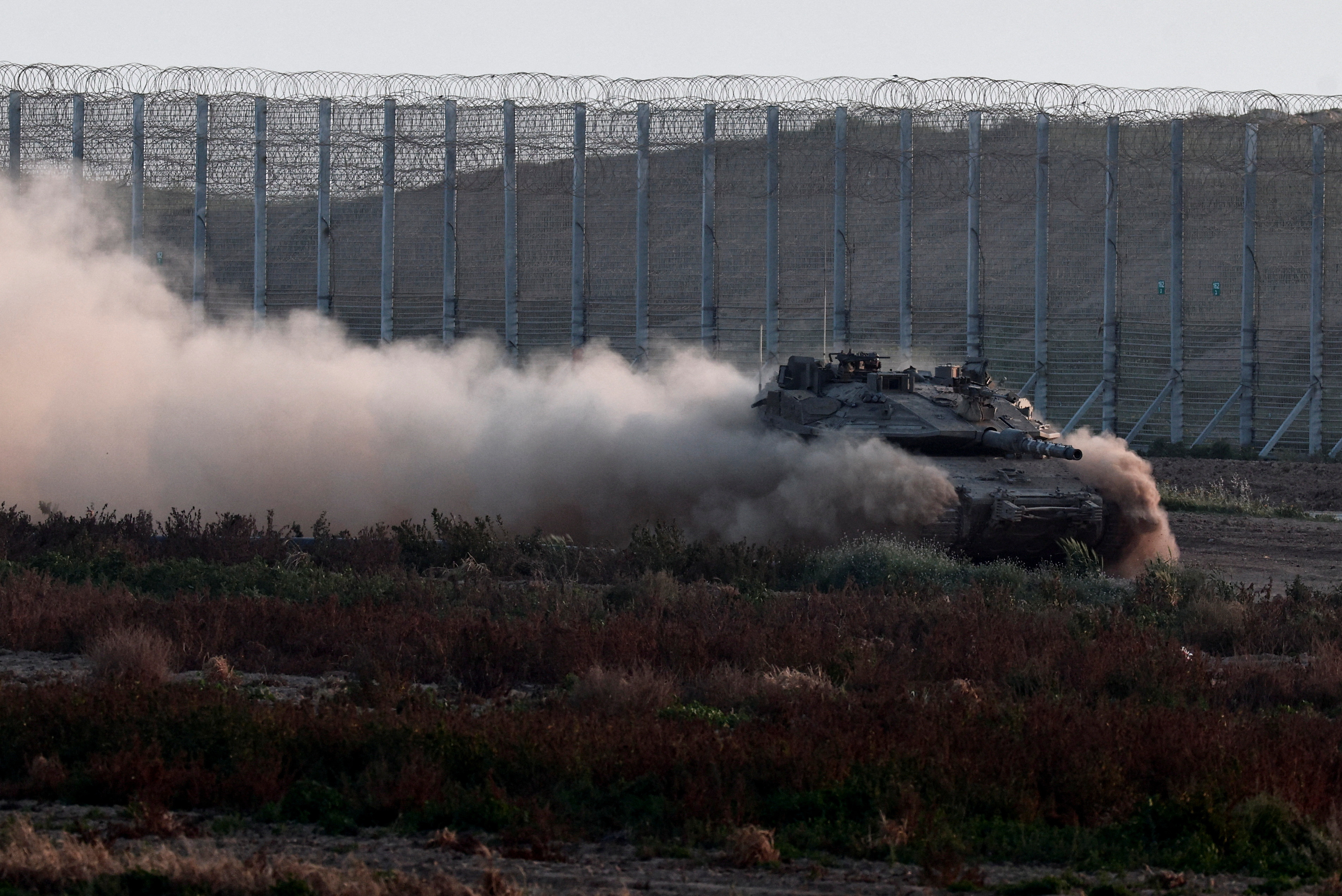 A tank maneuvres near the Israel-Gaza border, as seen from Southern Israel