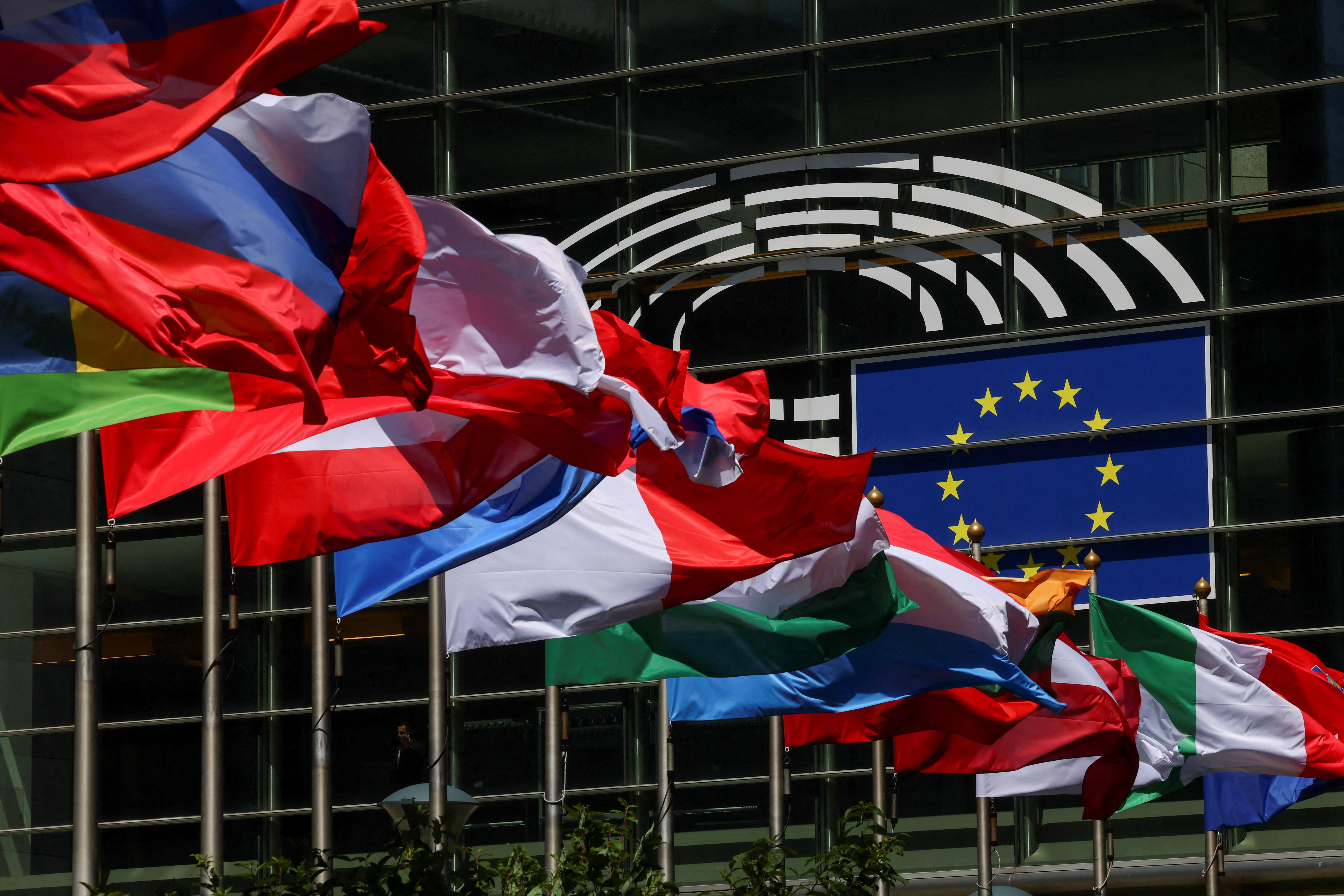 Flags flutter outside the European Parliament in Brussels