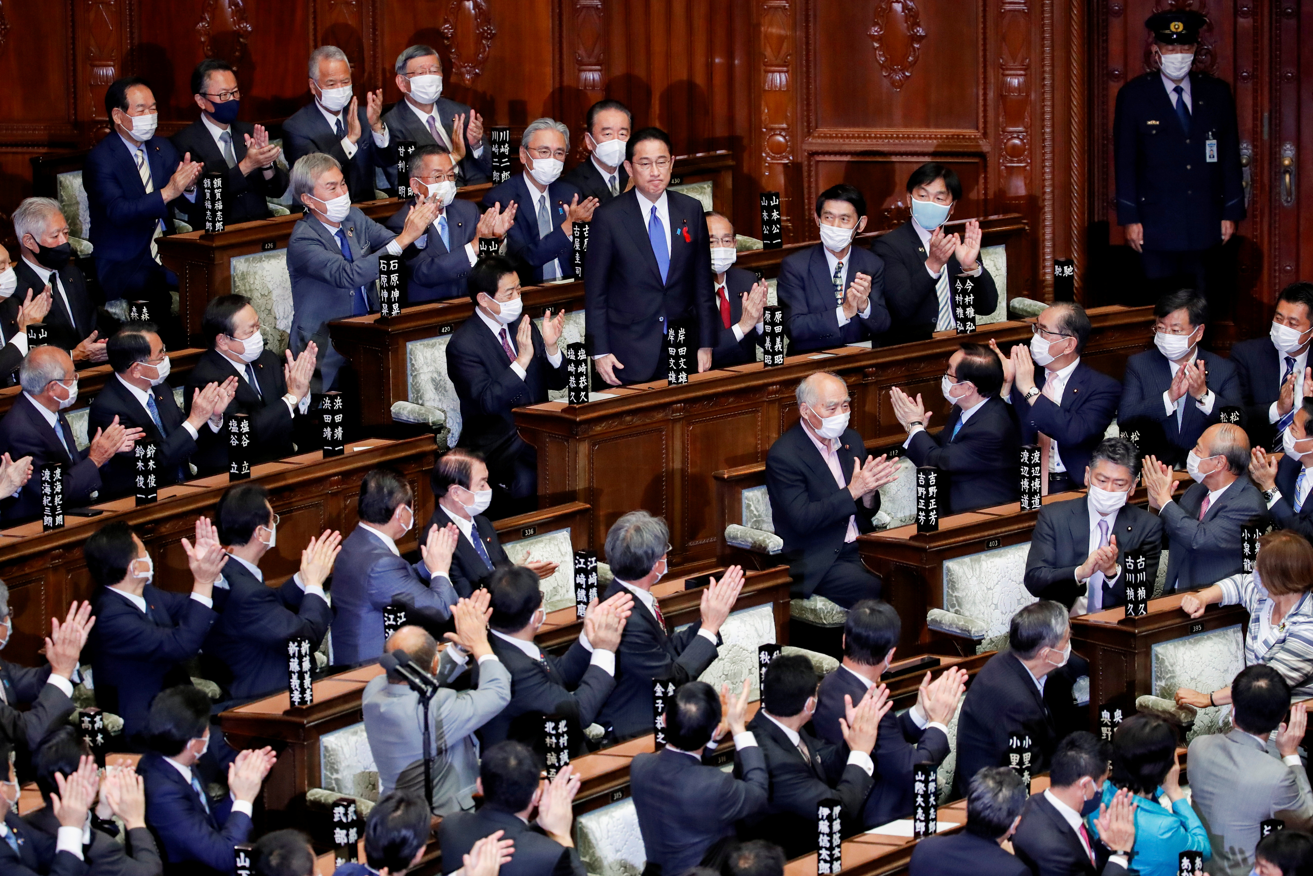 Japan's newly-elected Prime Minister Fumio Kishida is applauded after being chosen as the new prime minister, at the Lower House of Parliament in Tokyo