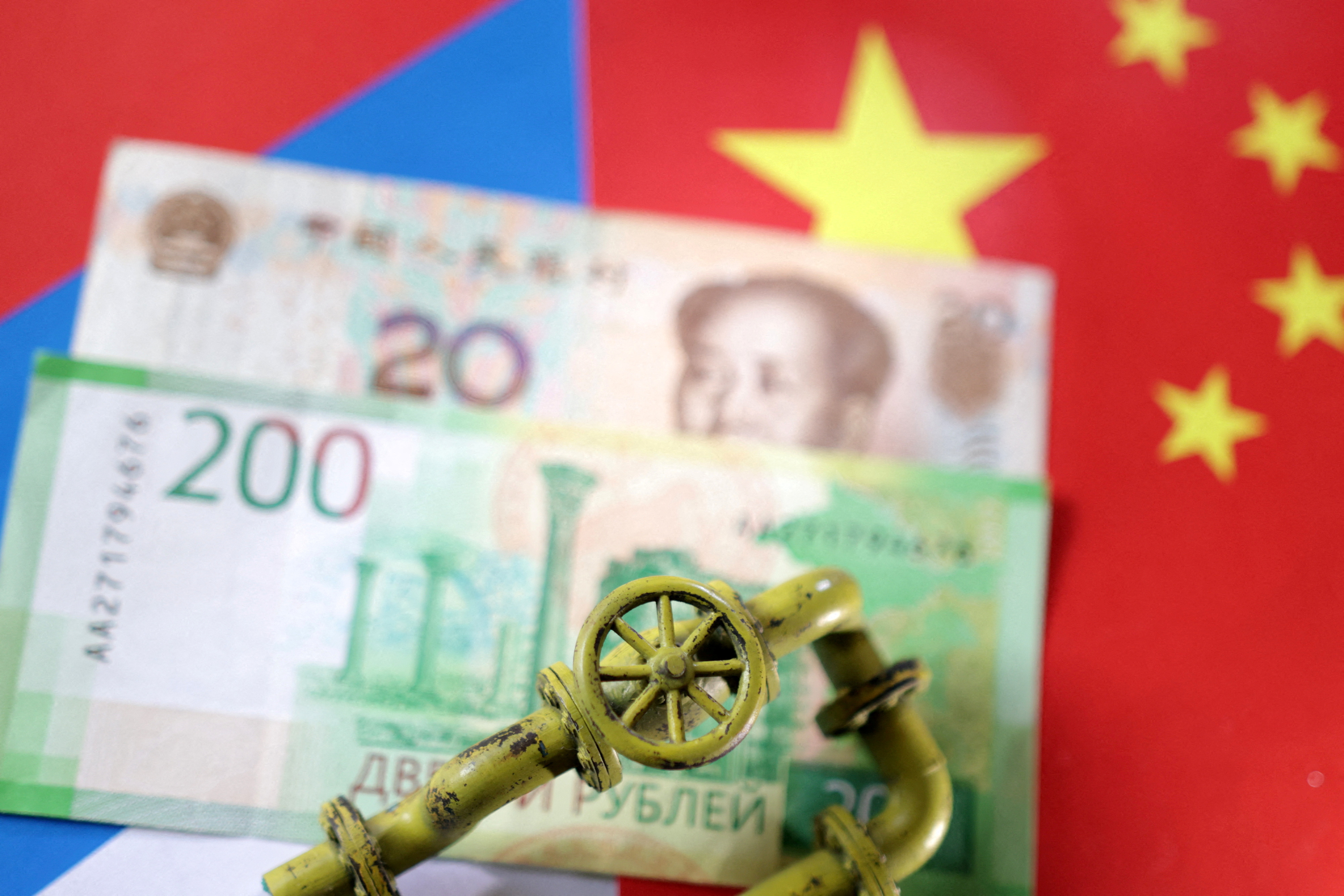 Illustration shows model of natural gas pipeline, Russian and Chinese flags and Yuan and Rouble banknotes