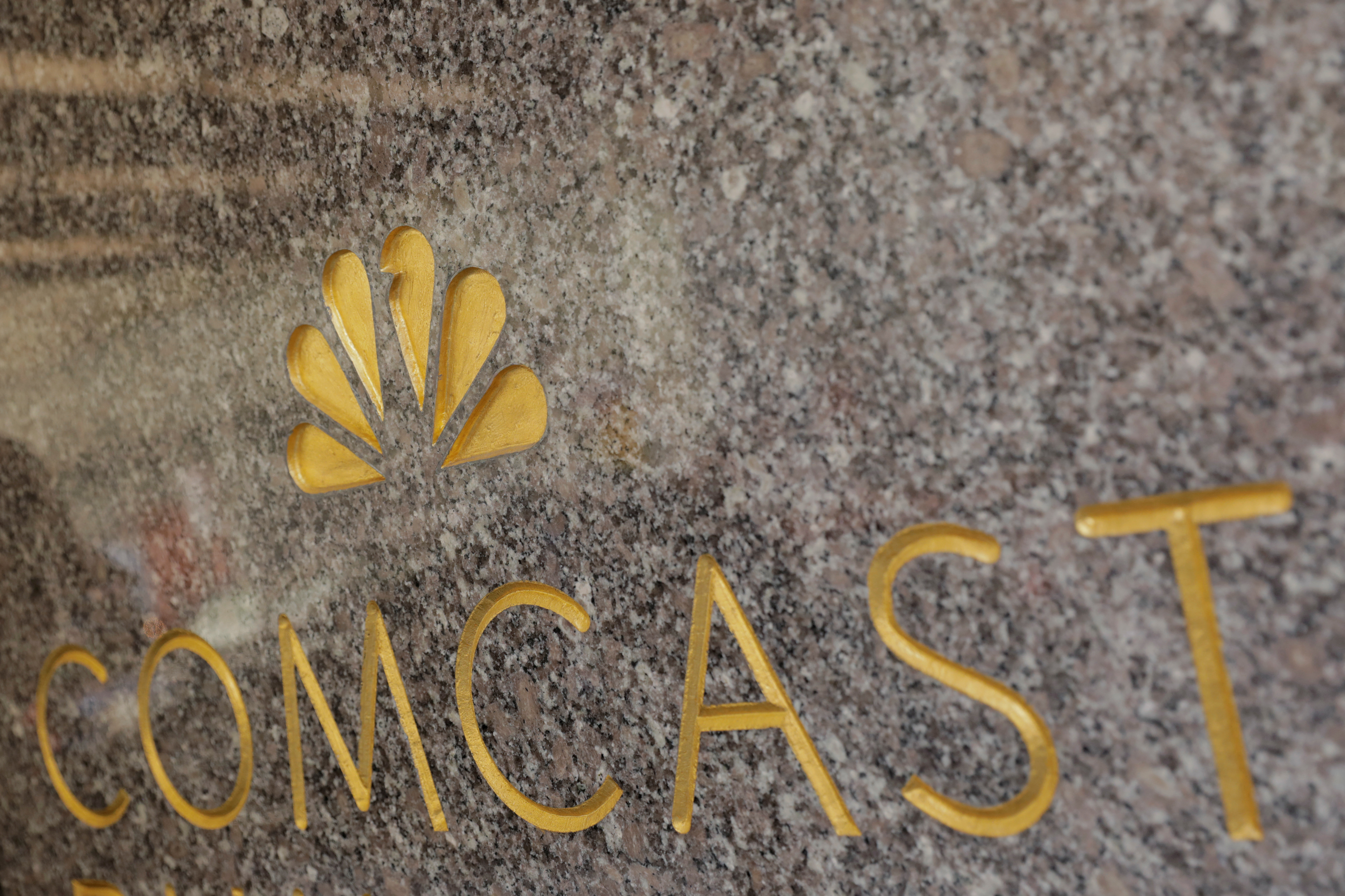 The NBC and Comcast logos are displayed on 30 Rockefeller Plaza in midtown Manhattan in New York