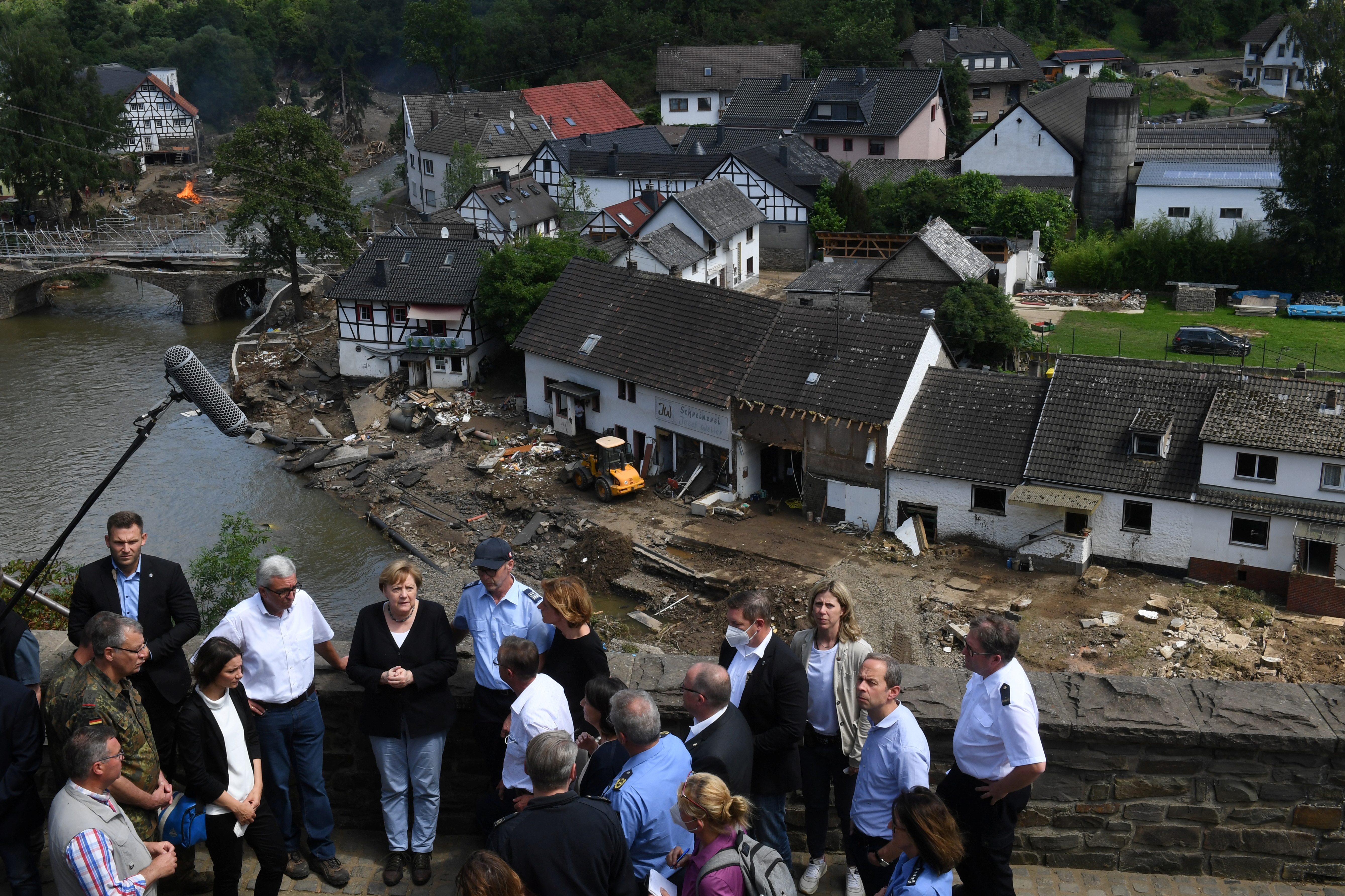 German Chancellor Angela Merkel and Rhineland-Palatinate State Premier Malu Dreyer speak to people as they stand on a bridge during their visit in the flood-ravaged areas, in Schuld near Bad Neuenahr-Ahrweiler, Rhineland-Palatinate state, Germany, July 18, 2021. Christof Stache/Pool via REUTERS