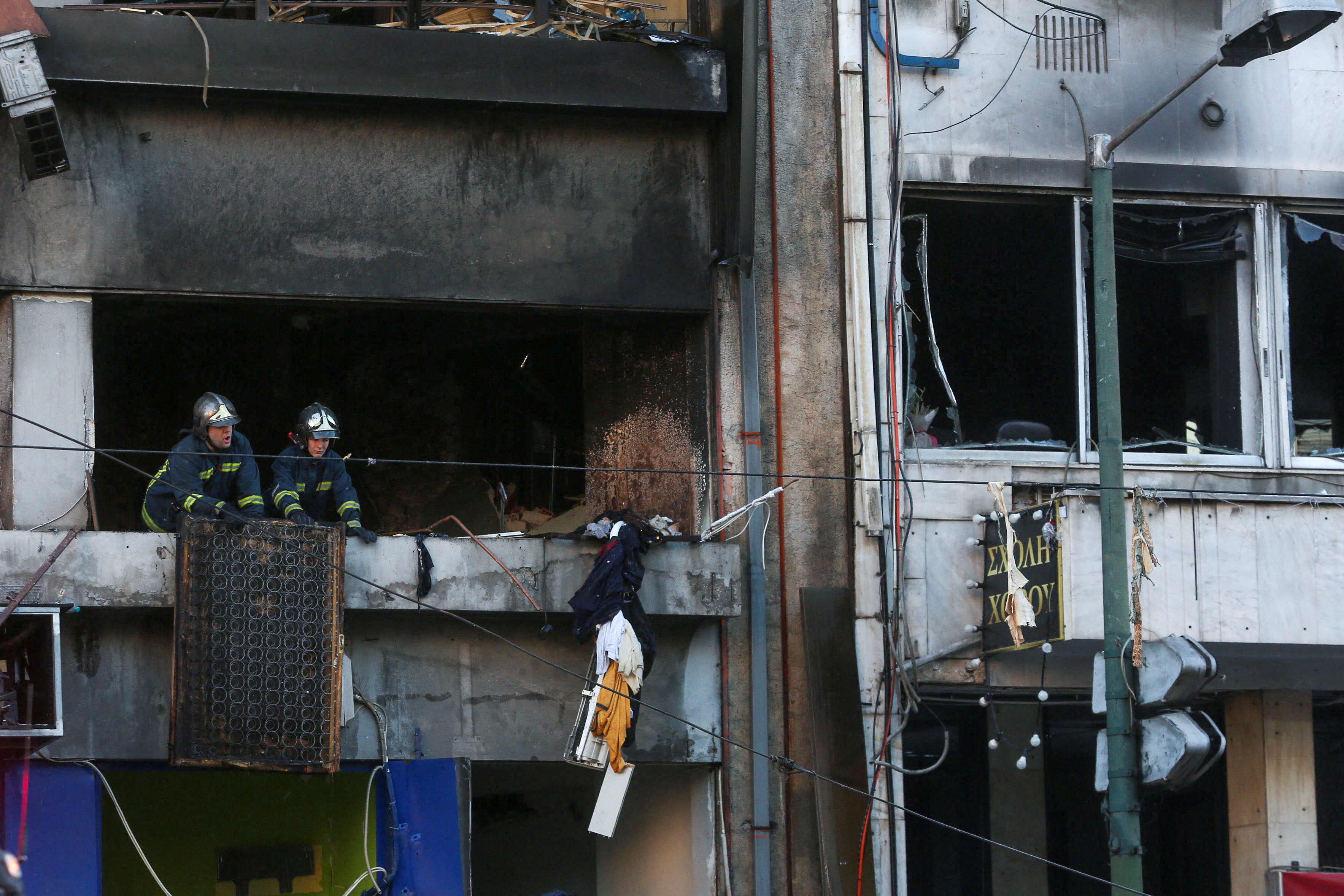 Firefighters are seen inside a building after a blast in Athens