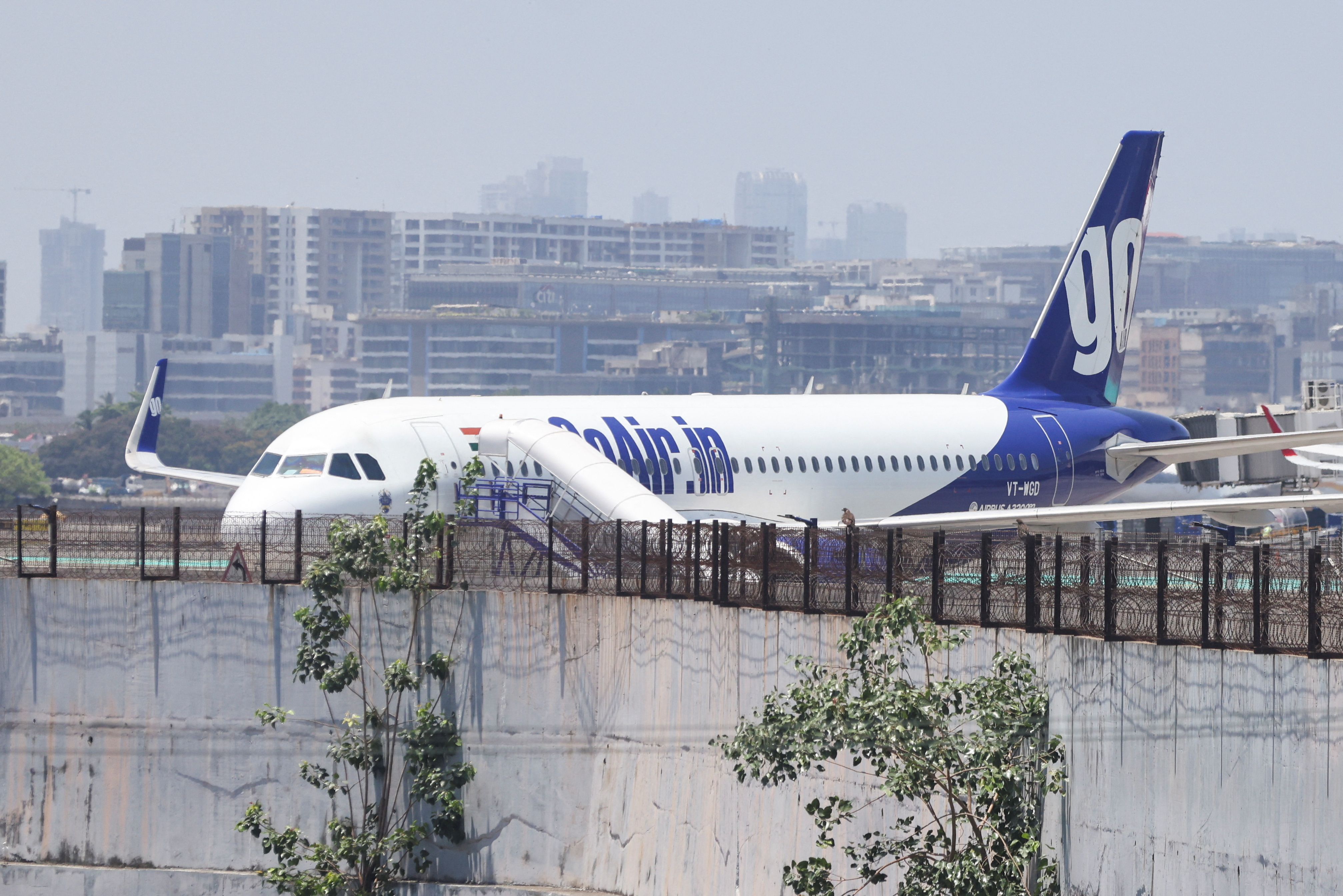 A Go First airline, formerly known as GoAir, passenger aircraft is parked at the Chhatrapati Shivaji International Airport in Mumbai