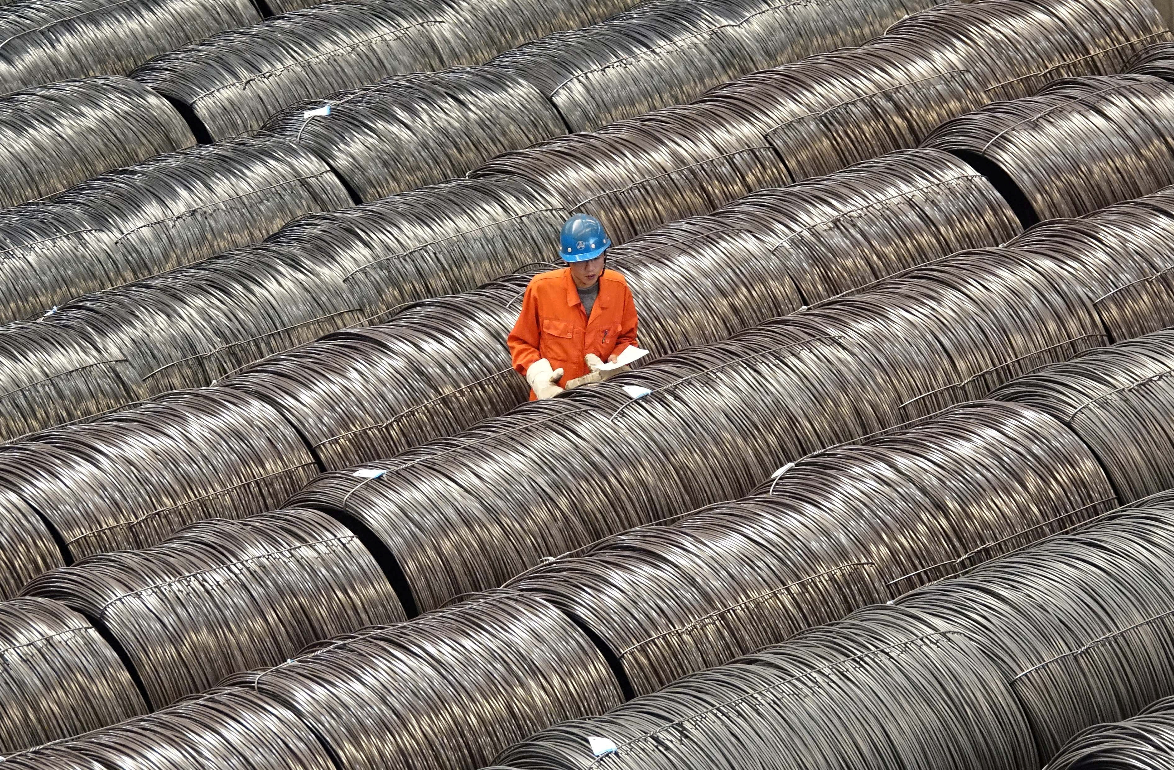 A worker checks steel wires at a warehouse in Dalian, Liaoning province