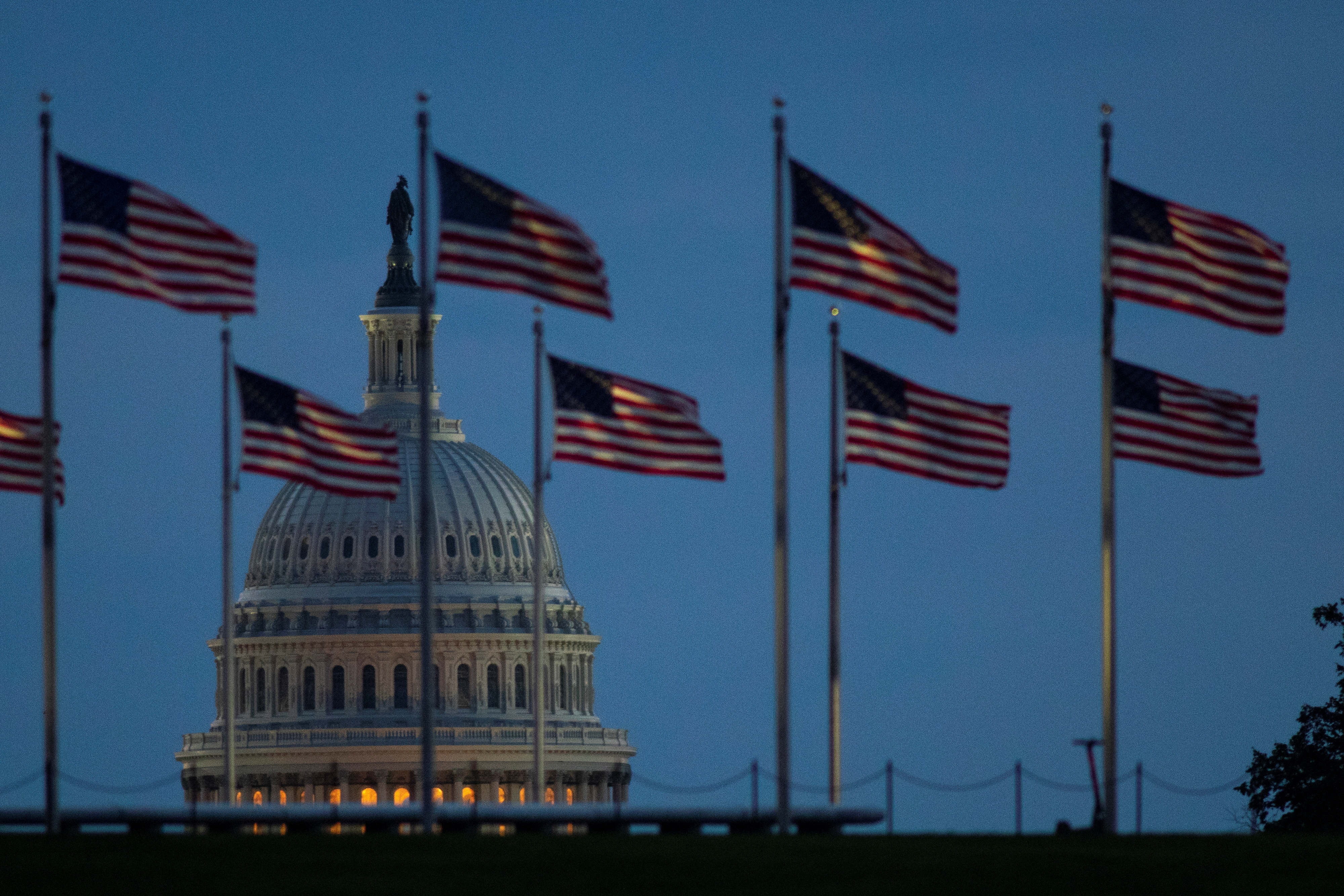 The U.S. Capitol building is seen illuminated at dawn along the National Mall in Washington