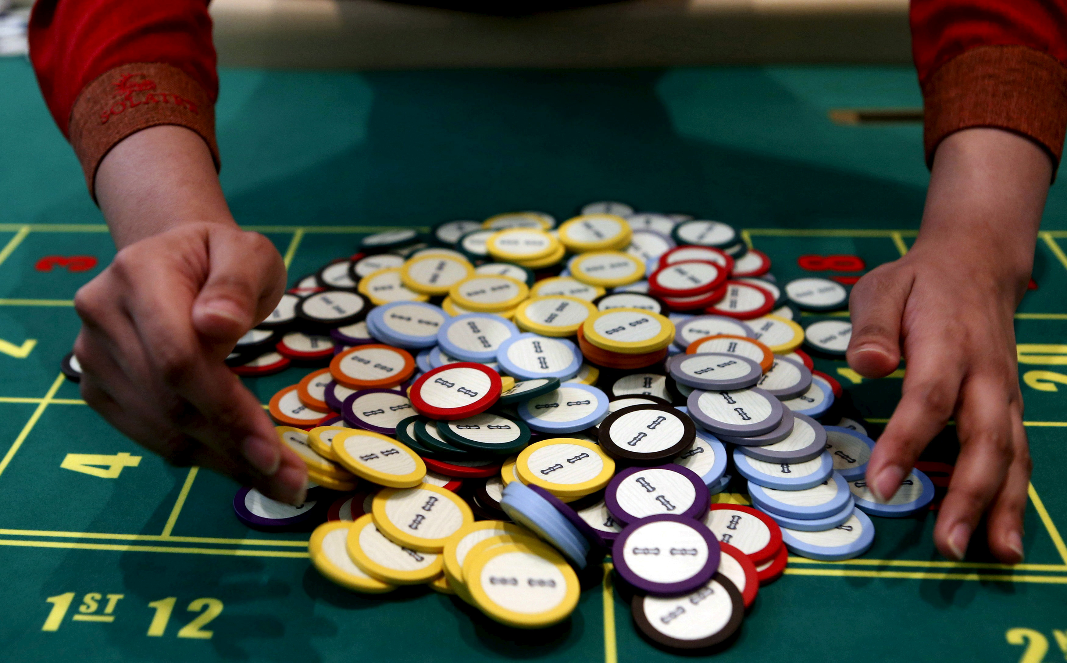 A casino dealer collects chips at a roulette table in Pasay city, Metro Manila