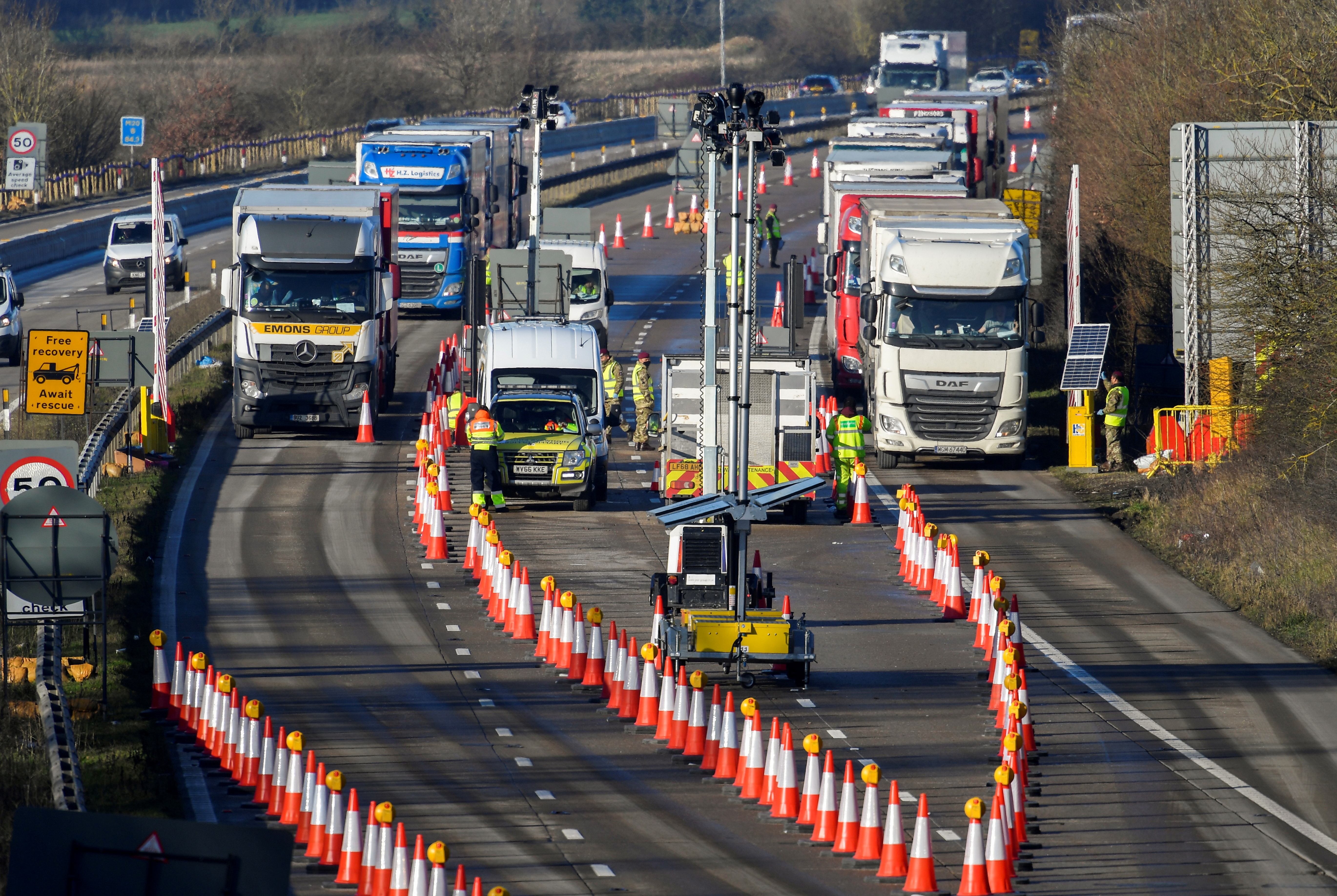 Freight lorries are stopped to undergo checks on the M20 motorway as they head towards the Eurotunnel and Port of Dover, bound for France, Ashford, Britain, December 31, 2020. REUTERS/Toby Melville