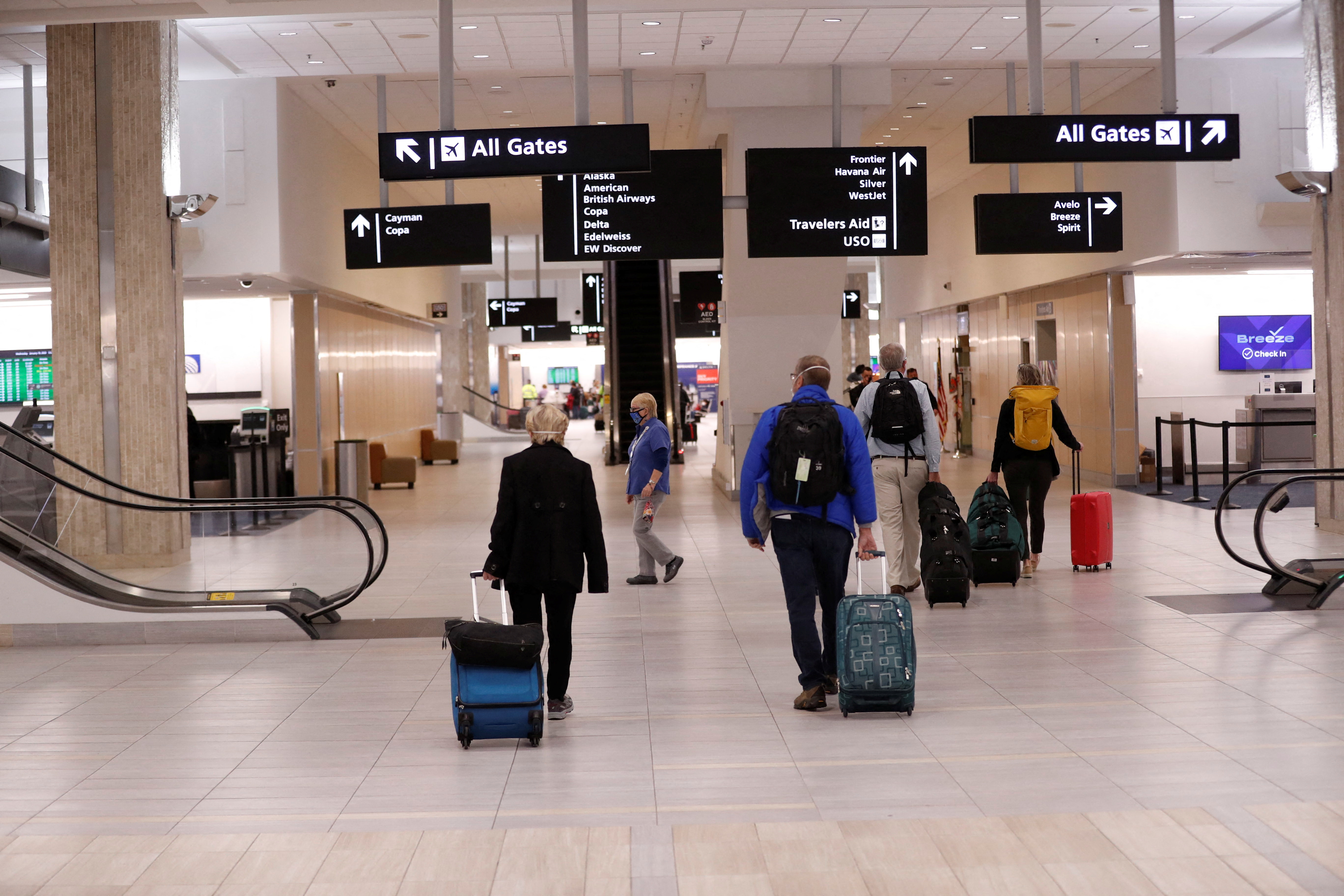 Airline passengers walk inside the Tampa International Airport