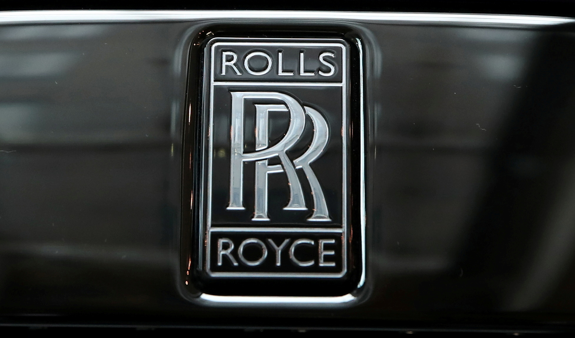 The badge of a Rolls-Royce Black Badge Dawn car is seen at a dealership in London