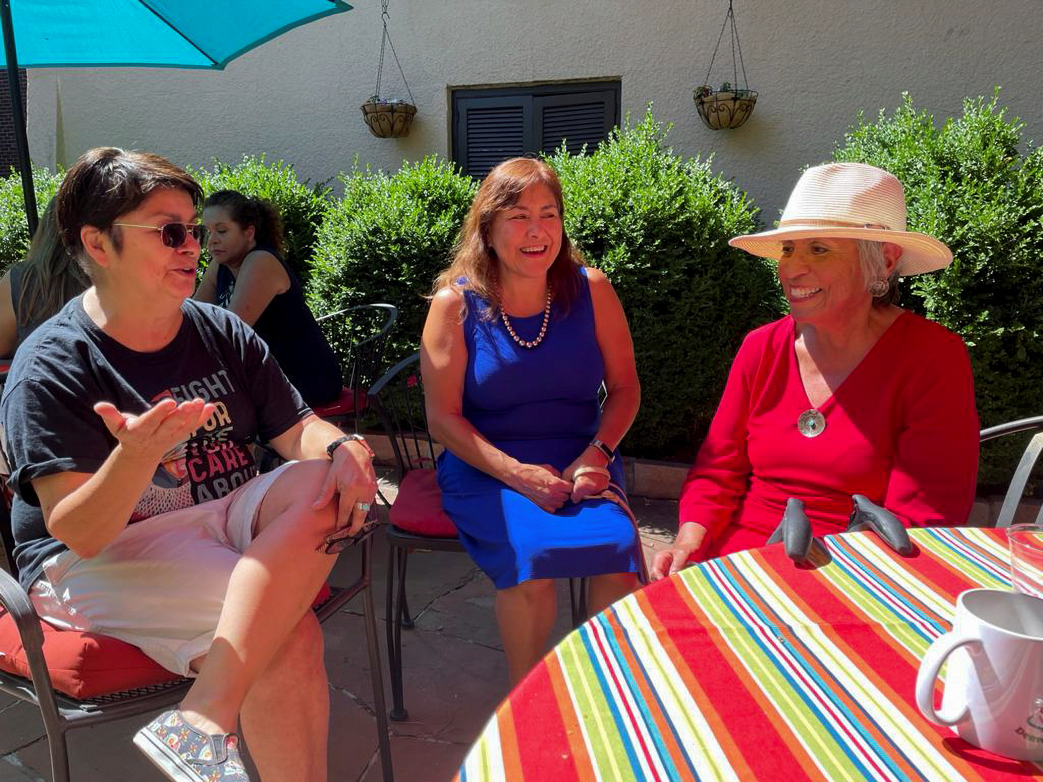 Rosemary Rodriguez, Cecelia Espenoza, and Denise Maes chat at a weekly cafecito gathering in Park Hill neighborhood in Denver
